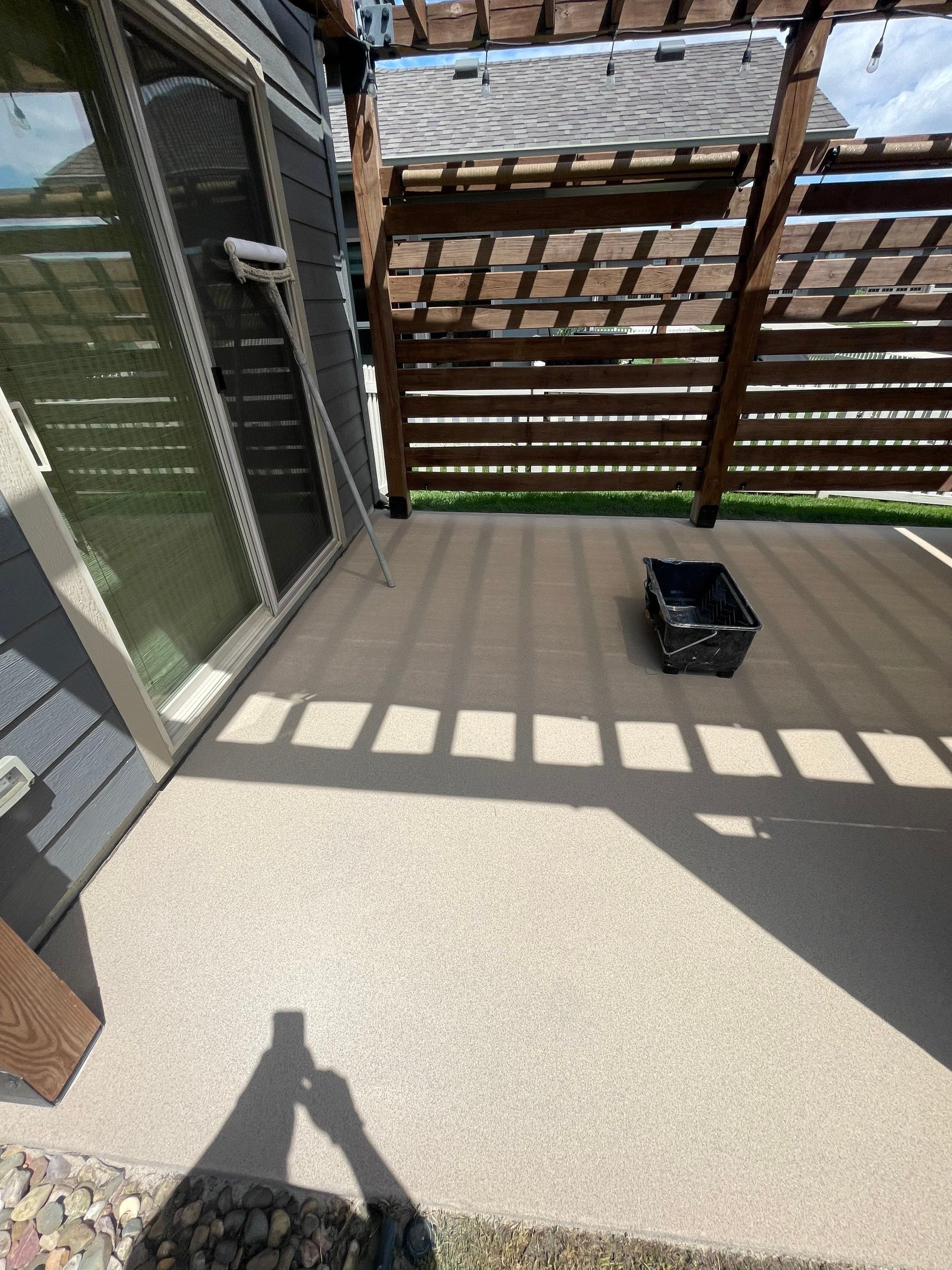 Textured Concrete Patio Coating and Custom Privacy Pergola in Sioux Falls by Select Painting, Coatings & Garage Cabinets