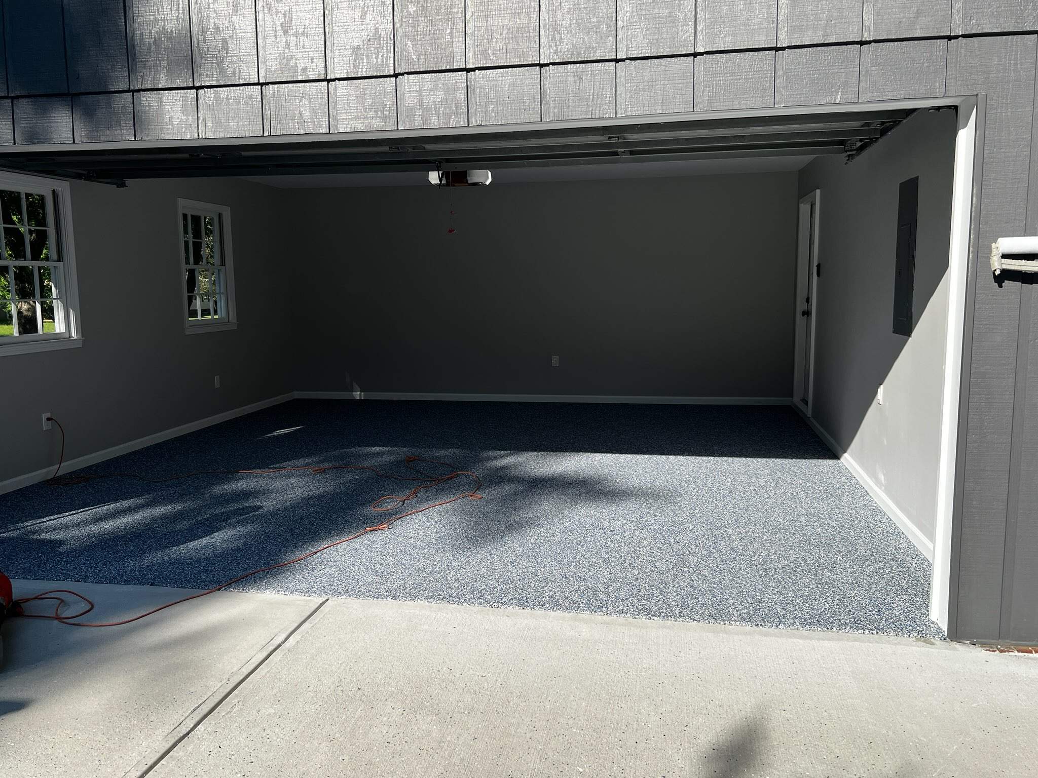 Snellville Garage Remodel Featuring Epoxy Floors and Board and Batten Siding by Swift Home Renovations