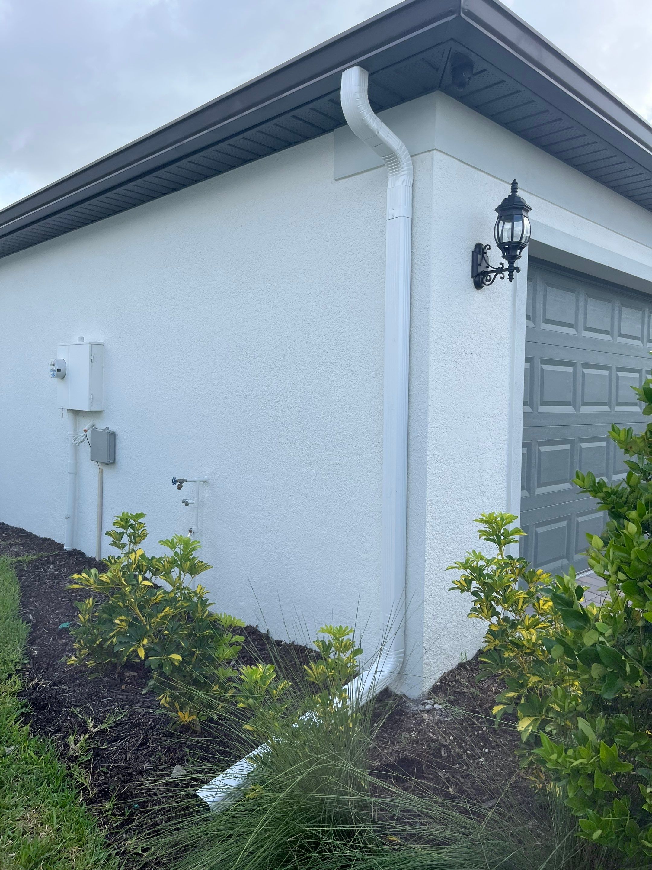 Dark Bronze Gutters and White Downspouts in Sarasota FL by Gutter Professors