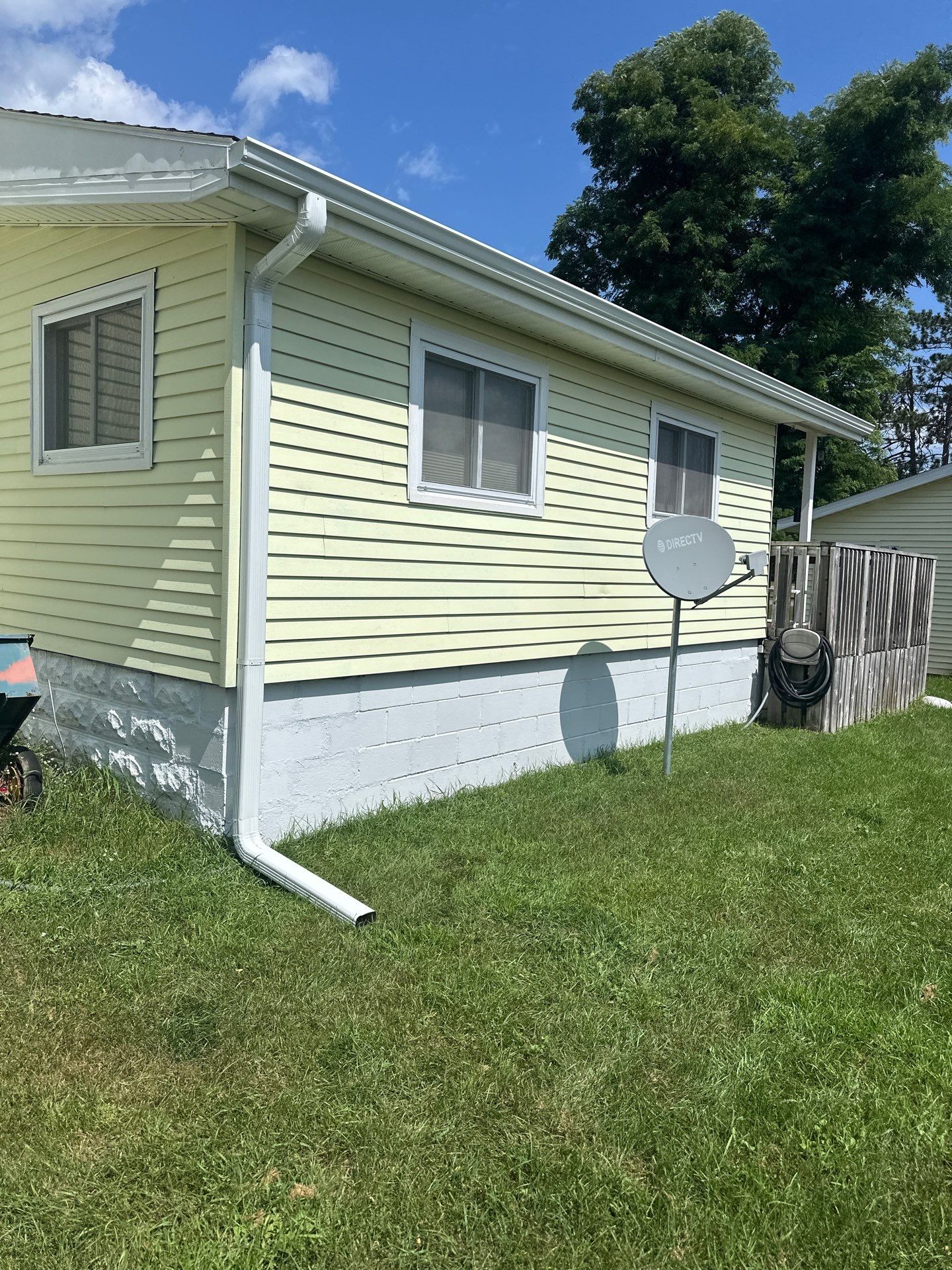 White Gutter and Downspout Installation for Lewiston Residence by Rainbow Seamless Systems