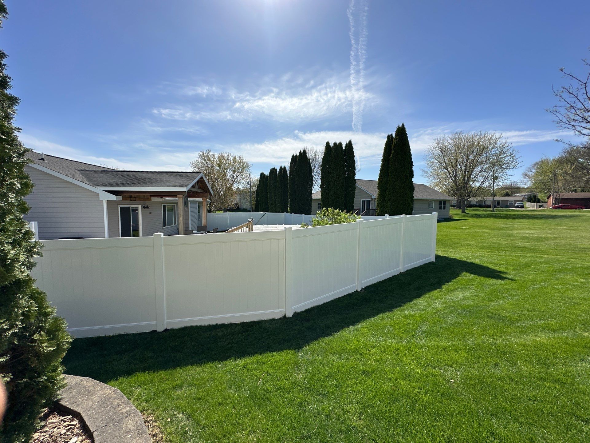 White Vinyl Privacy Fence Installation in Raymond, Iowa by Perfect Picket Fence and Stain