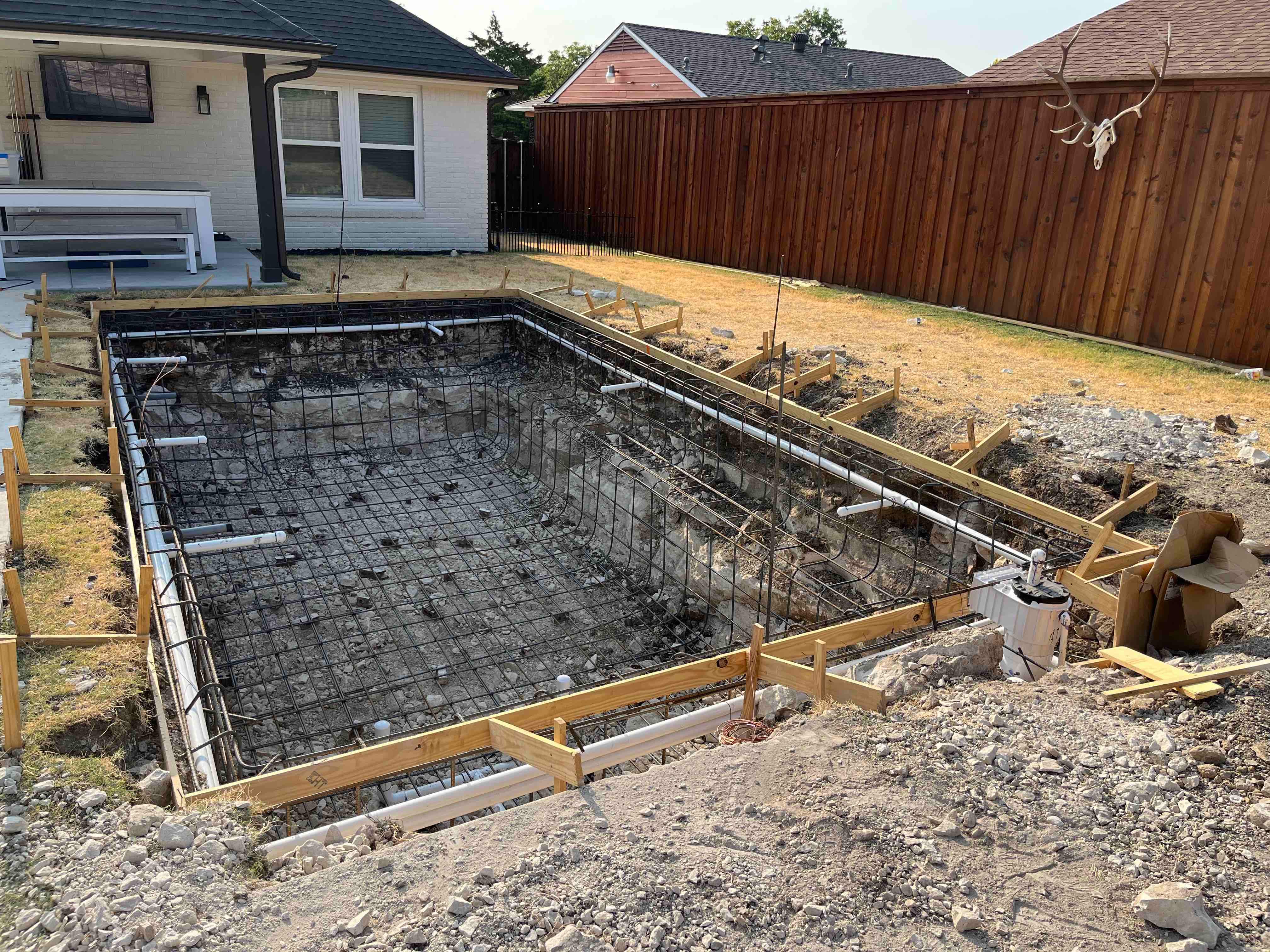 Modern Pool with Dark Interior and Deck Jets by Pinnacle Pools and Spas - DFW