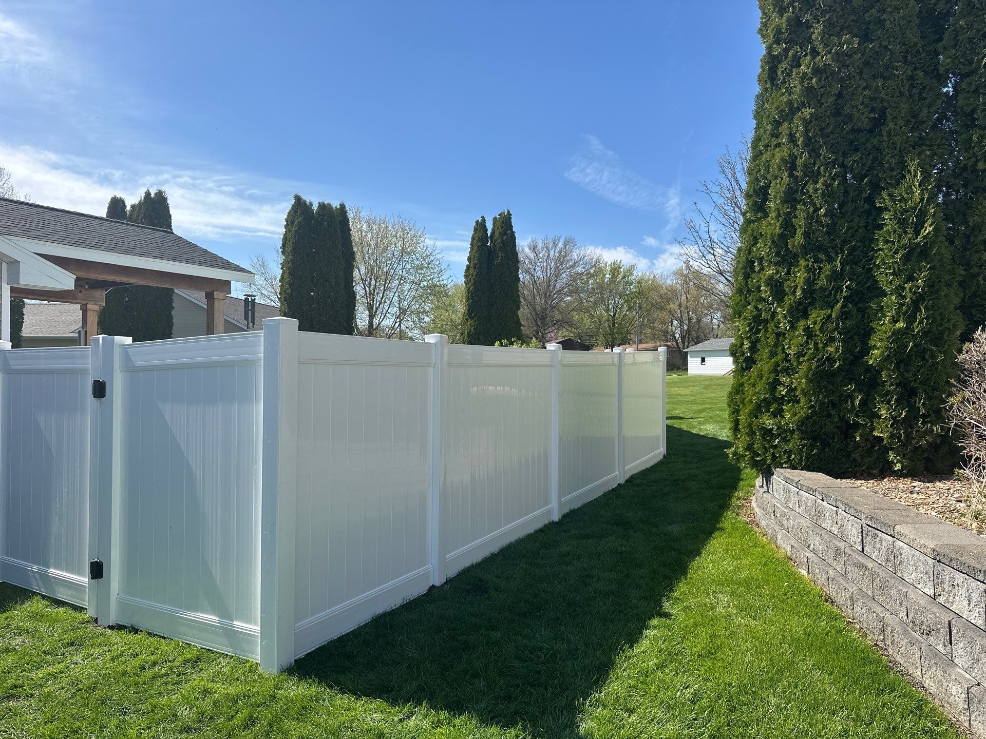 White Vinyl Privacy Fence Installation in Raymond, Iowa by Perfect Picket Fence and Stain