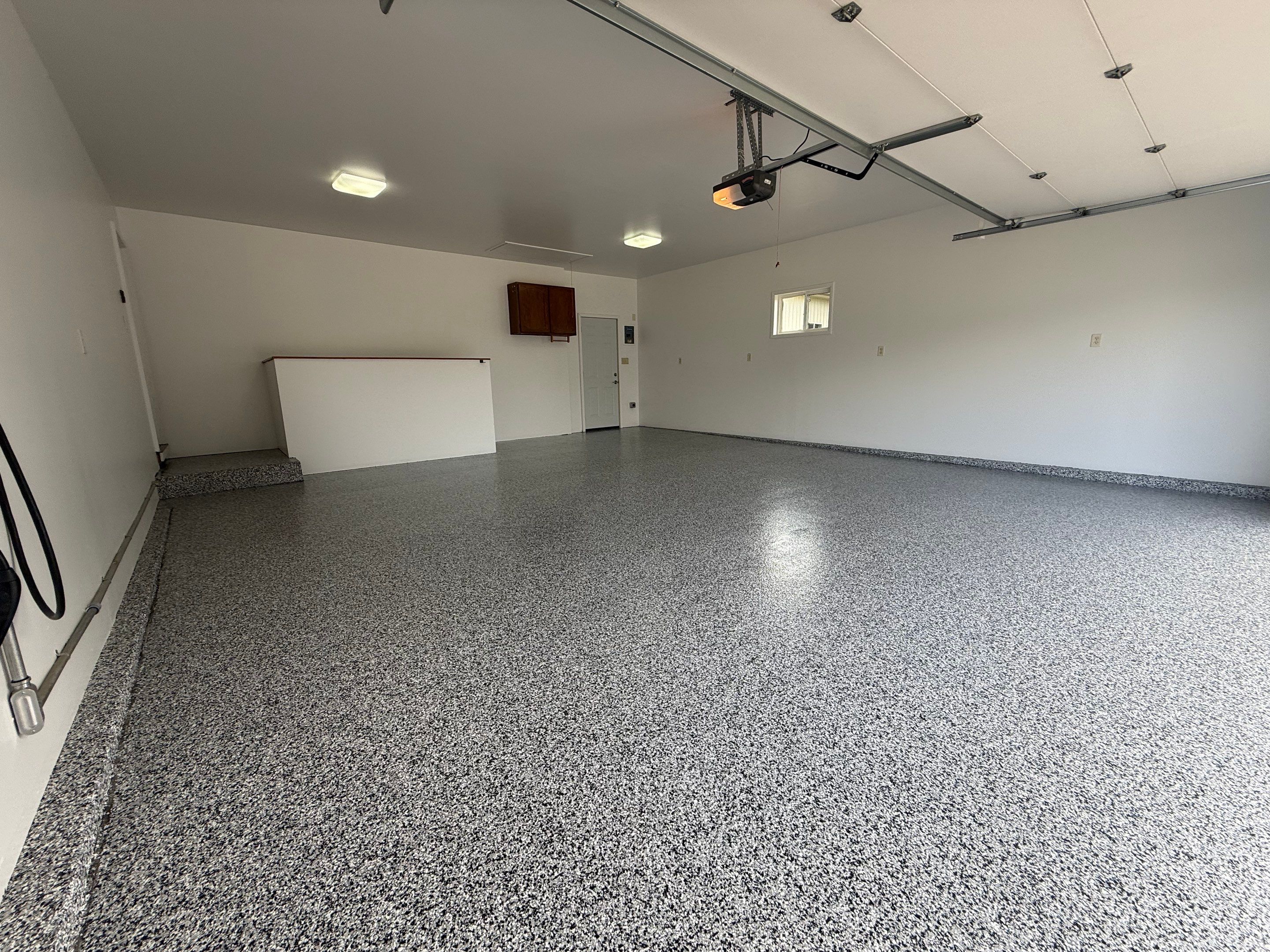 Full Garage Floor and Basement Stair Epoxy Coating in Sioux Falls by Select Painting, Coatings & Garage Cabinets