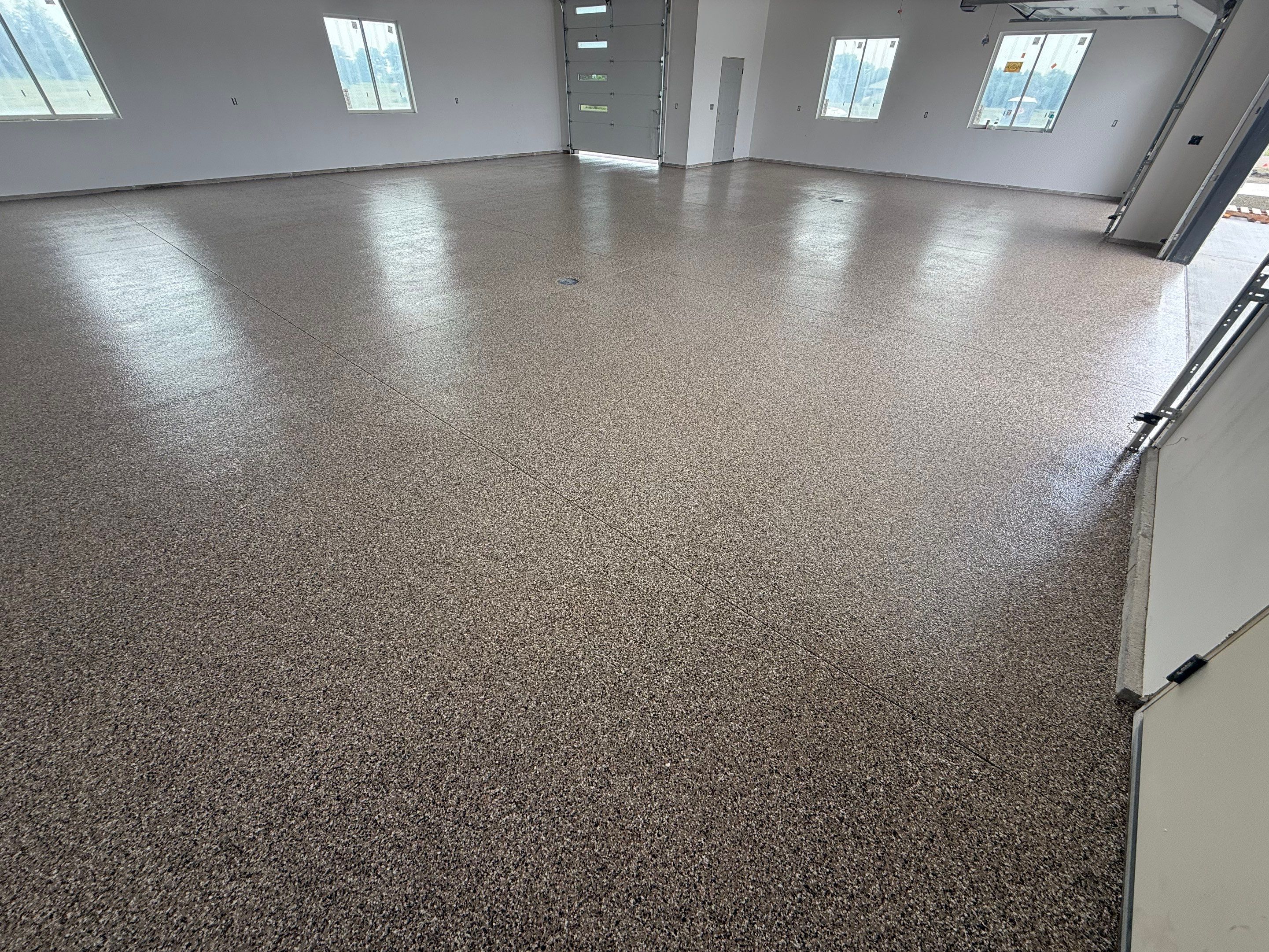 Multi-Bay Garage Concrete Coating and Floor Refinishing in South Dakota by Select Painting, Coatings & Garage Cabinets