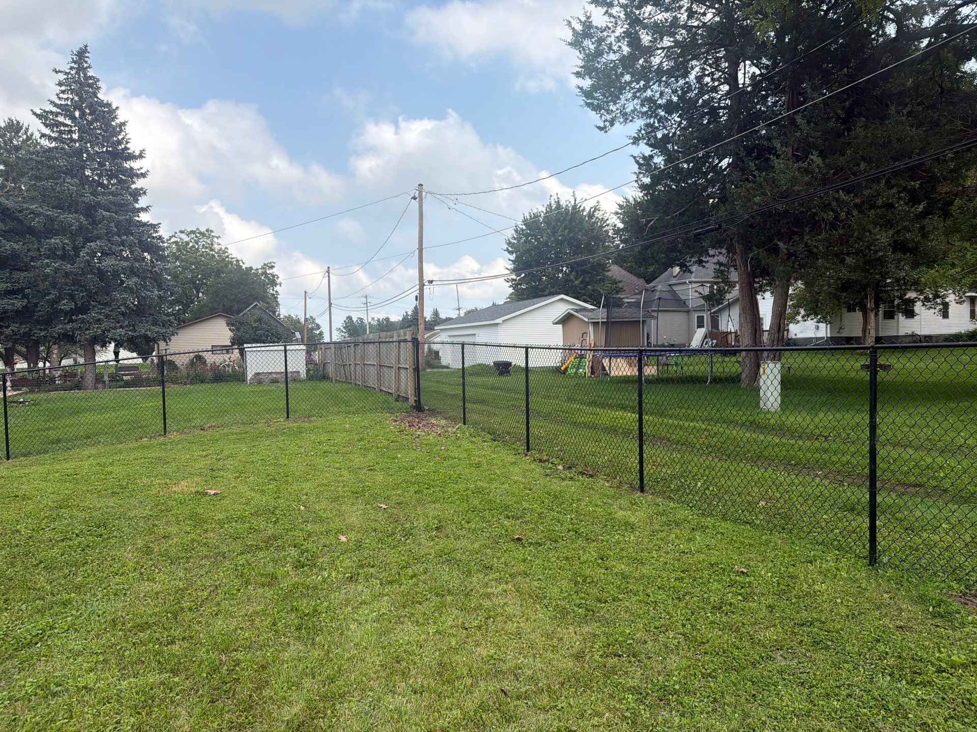 Residential Black Chain Link Fence Installation in Reinbeck by Perfect Picket Fence and Stain