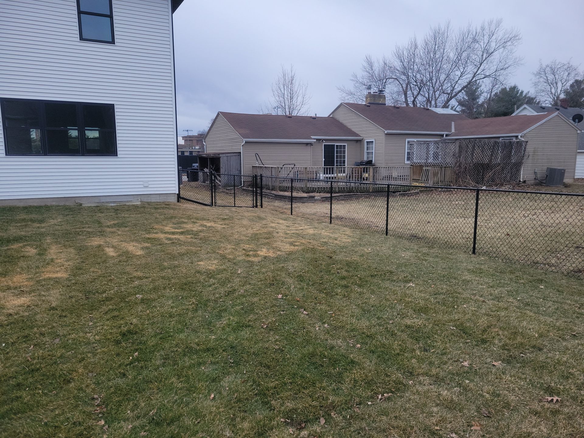 Black Chain Link Backyard Fence and Gate Installation in Cedar Falls by Perfect Picket Fence and Stain