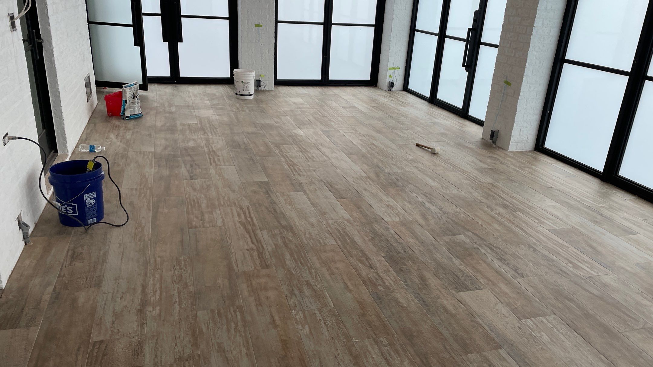 Instant Transformation of this Beautiful Sunroom by Footprints Floors of Coastal Carolina