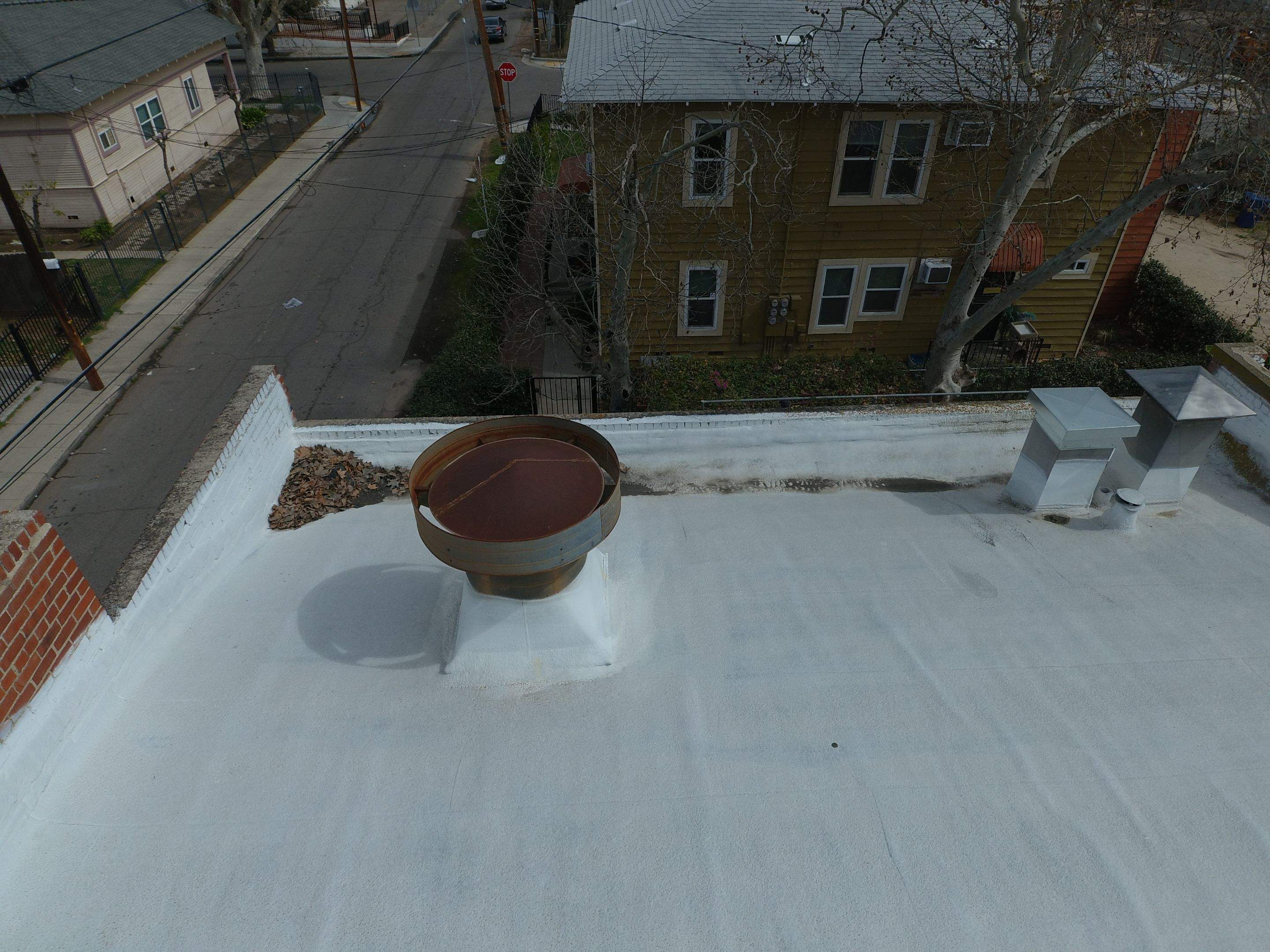 Polyurethane foam roof refurbish and recoating by Straight Edge Roofing Inc