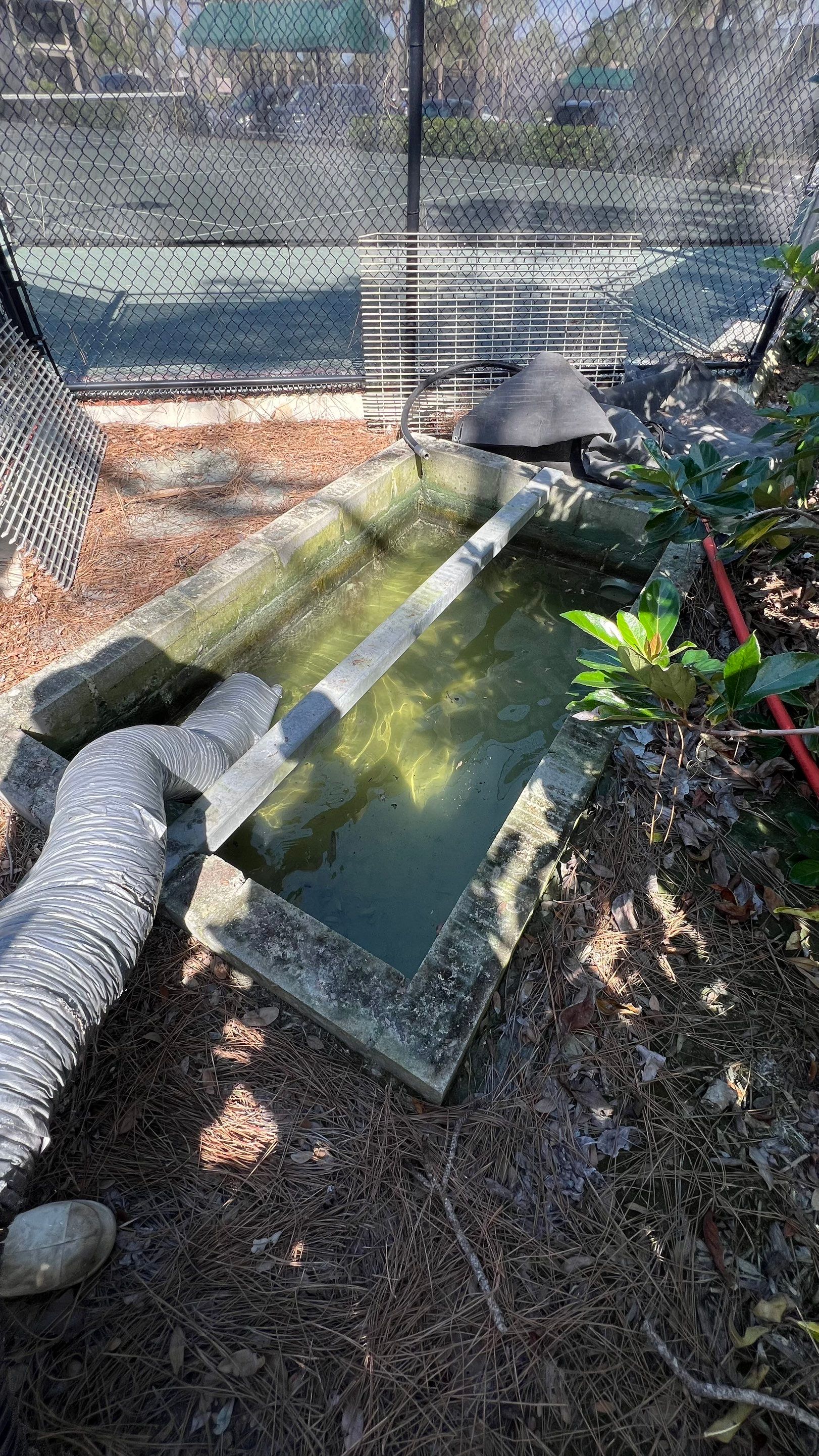 Pelican Landing Tennis Court Catch Basin Cleaning by APS Power & Water