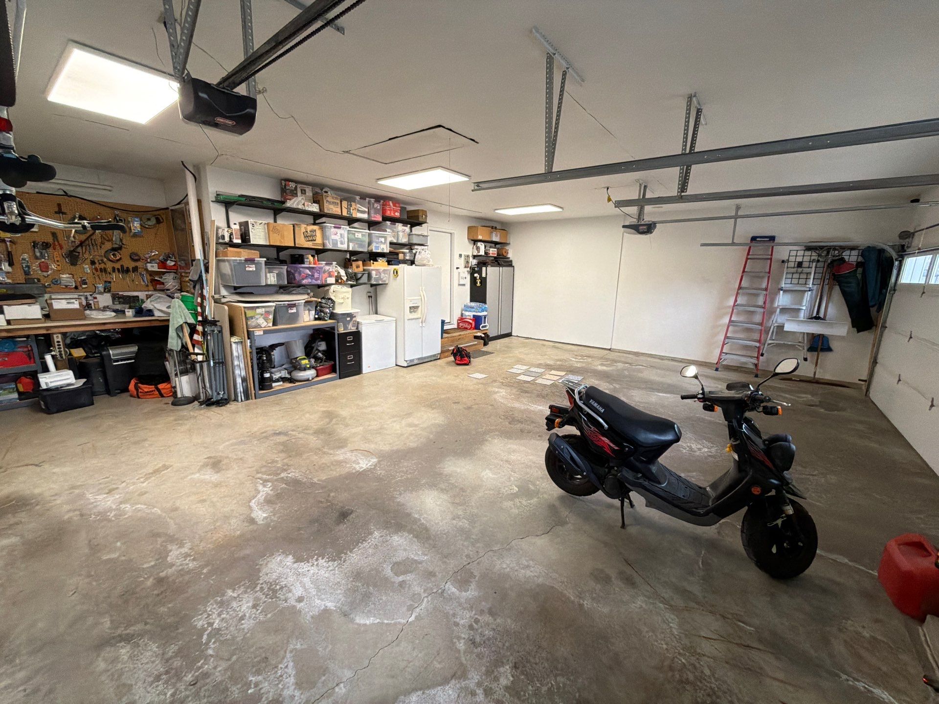 Feather Grey Garage Floor Coating Installation in Sioux Falls by Select Painting, Coatings & Garage Cabinets