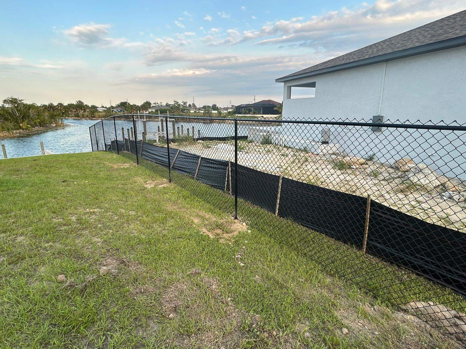 Black Chain Link Perimeter Fence and Utility Enclosure in Cape Coral by True Fence LLC