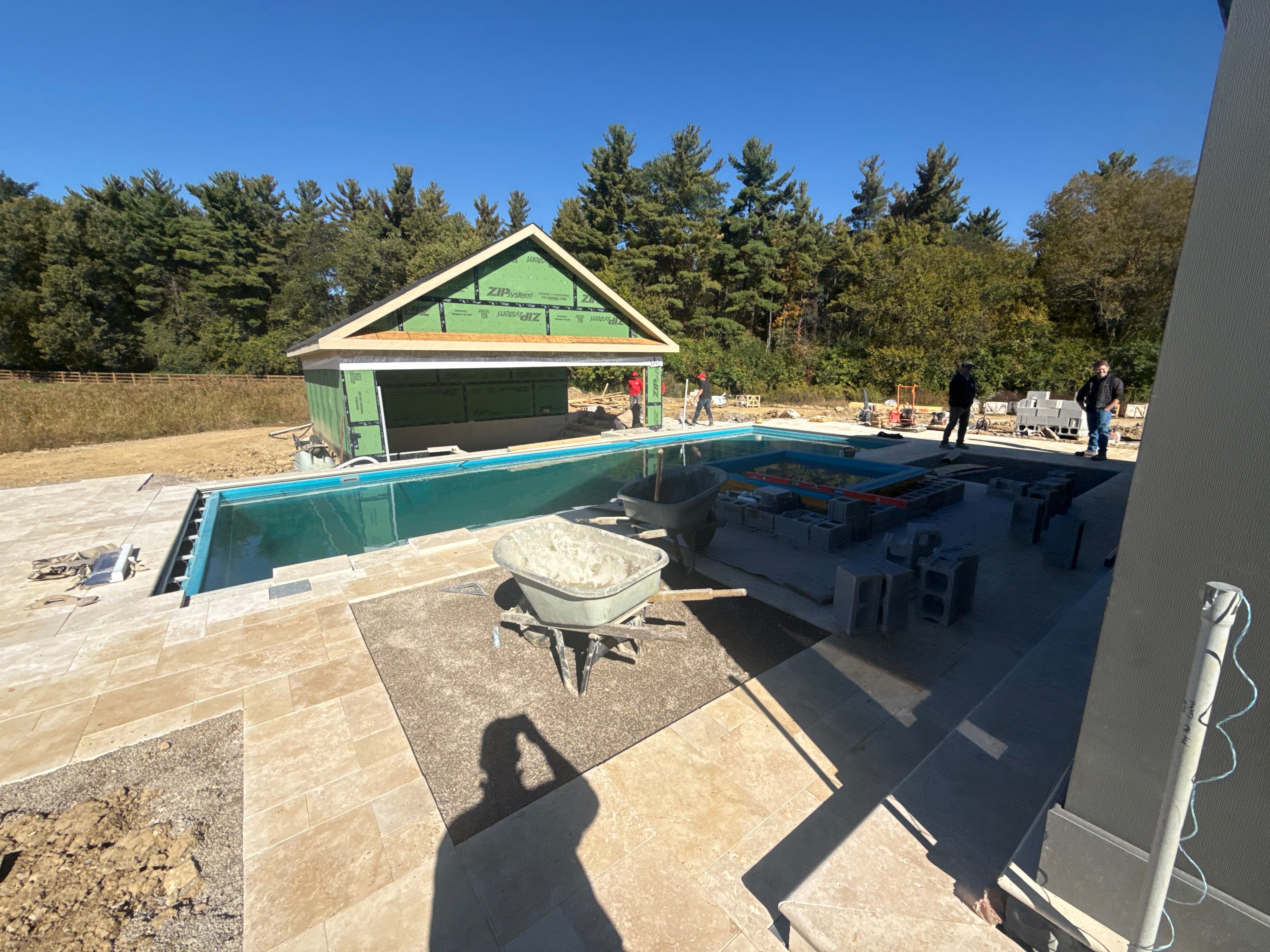 Custom Travertine Pool Deck with Artificial Turf Insets in Delaware by Southwest Greens Midwest