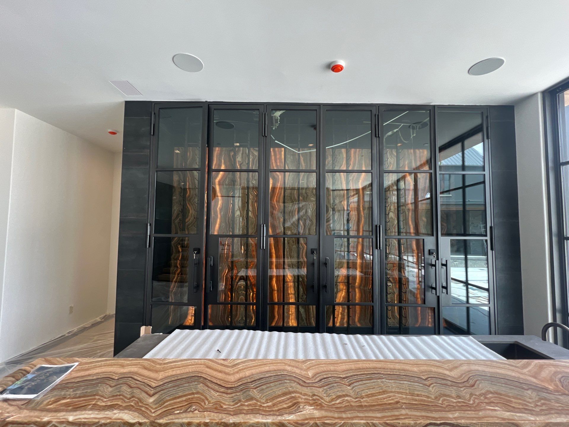 Custom Black-Framed Glass Wine Cellar Installation in Dallas by Solara Custom Living
