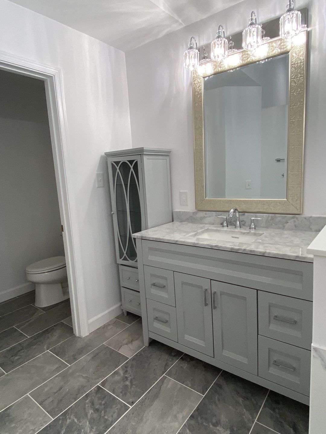 Bathroom Remodel using porcelain tiles , wood make vanetys , mirross , bathroom accessories  by Jesus Master Handyman LLC 