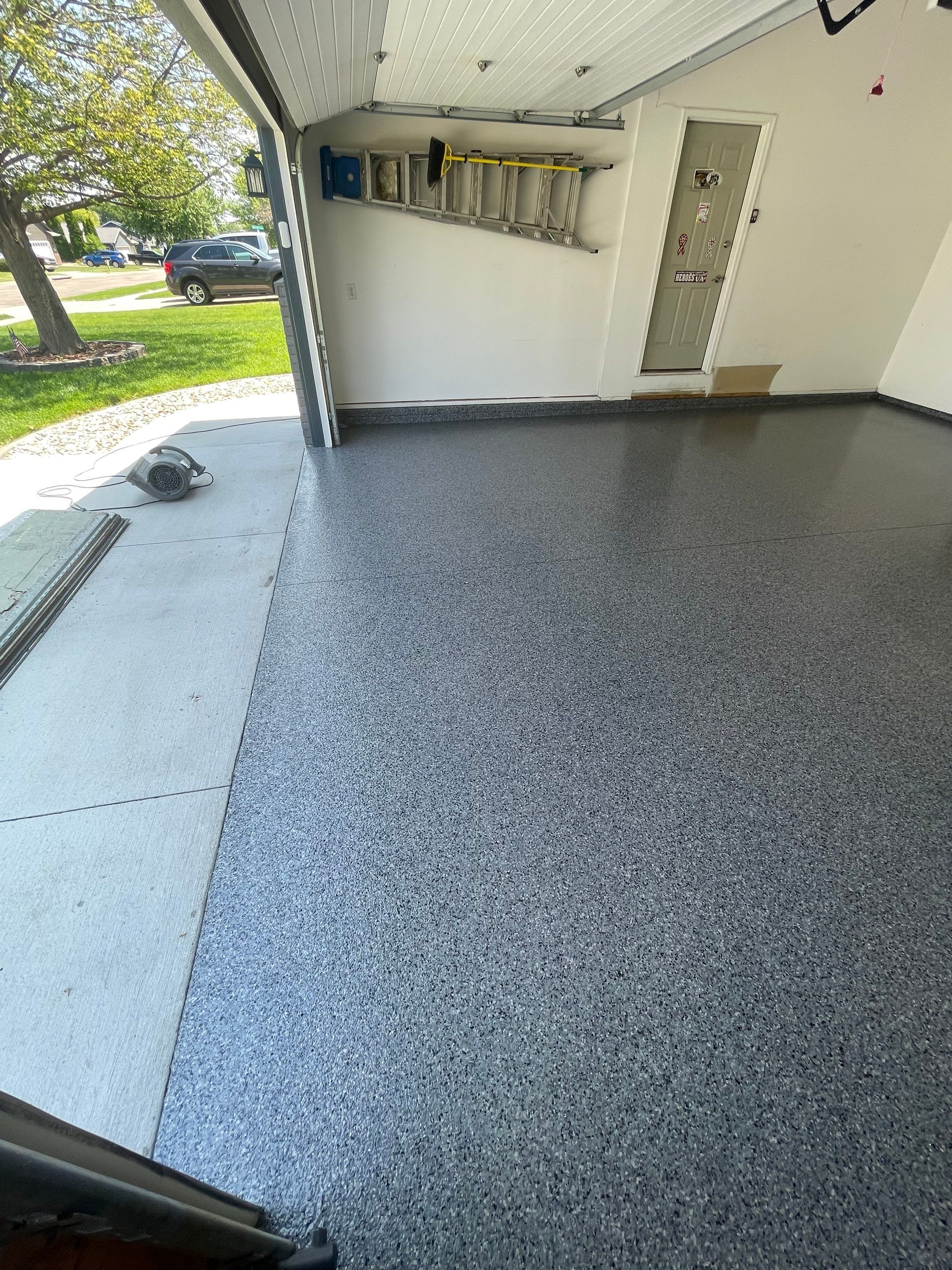 Sioux Falls Garage Floor Coating with Nightfall Decorative Chips by Select Painting, Coatings & Garage Cabinets