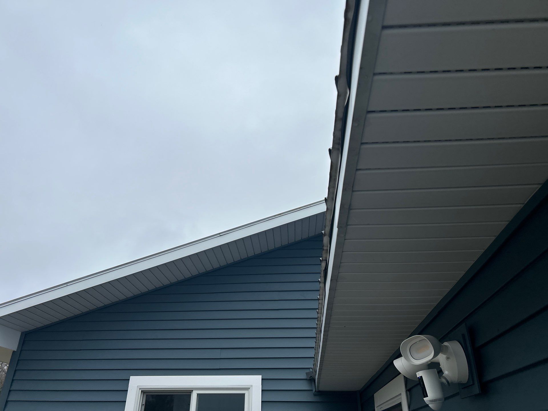 White Gutter and Downspout Installation for Boyne Falls Residential Property by Rainbow Seamless Systems