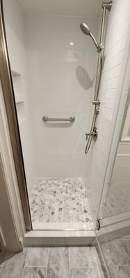 Full bathroom, tile shower, tile floor, tile wainscoting