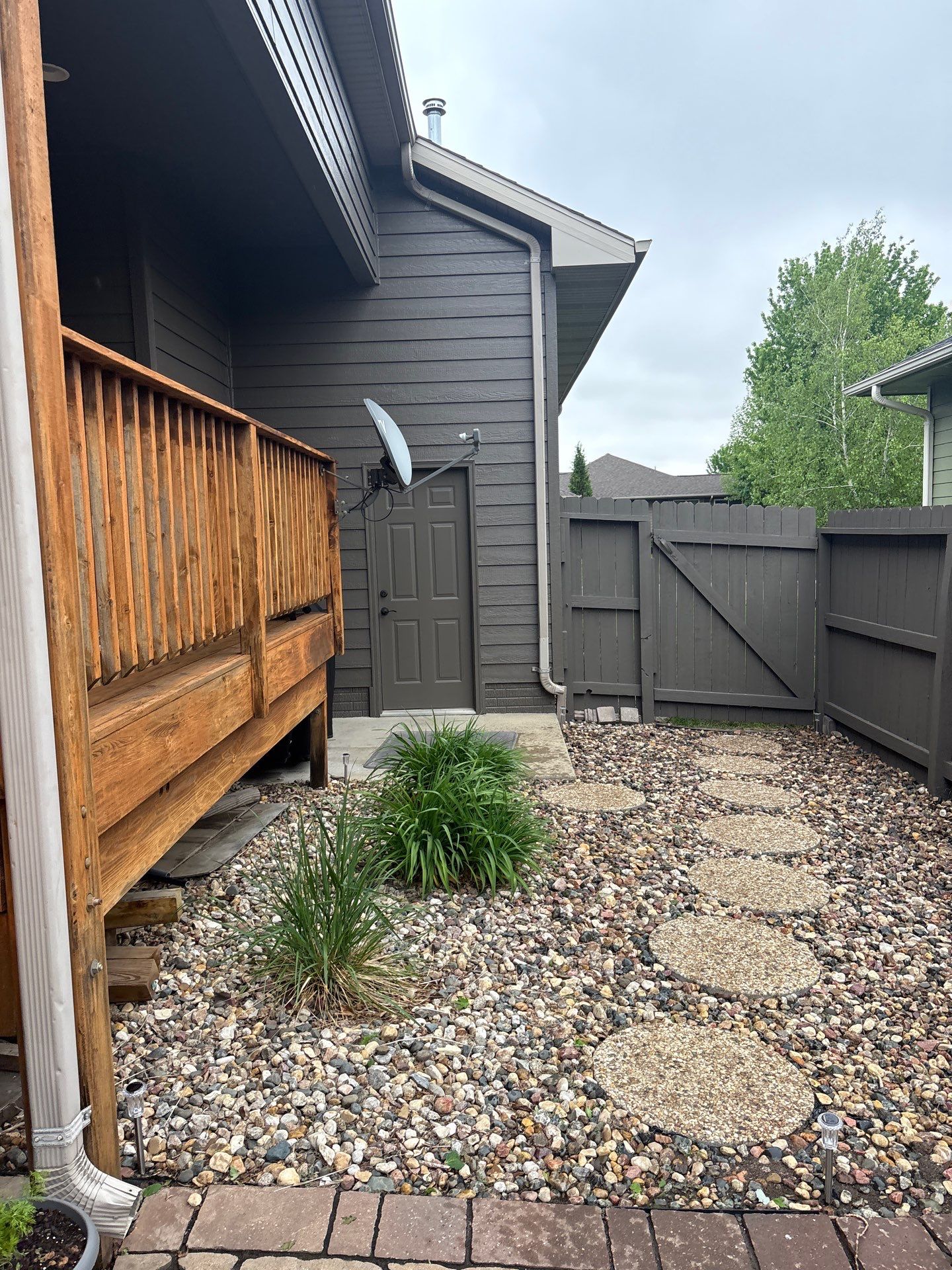 Sioux Falls Residential Exterior Update and Flagstone Pool Deck by Select Painting, Coatings & Garage Cabinets