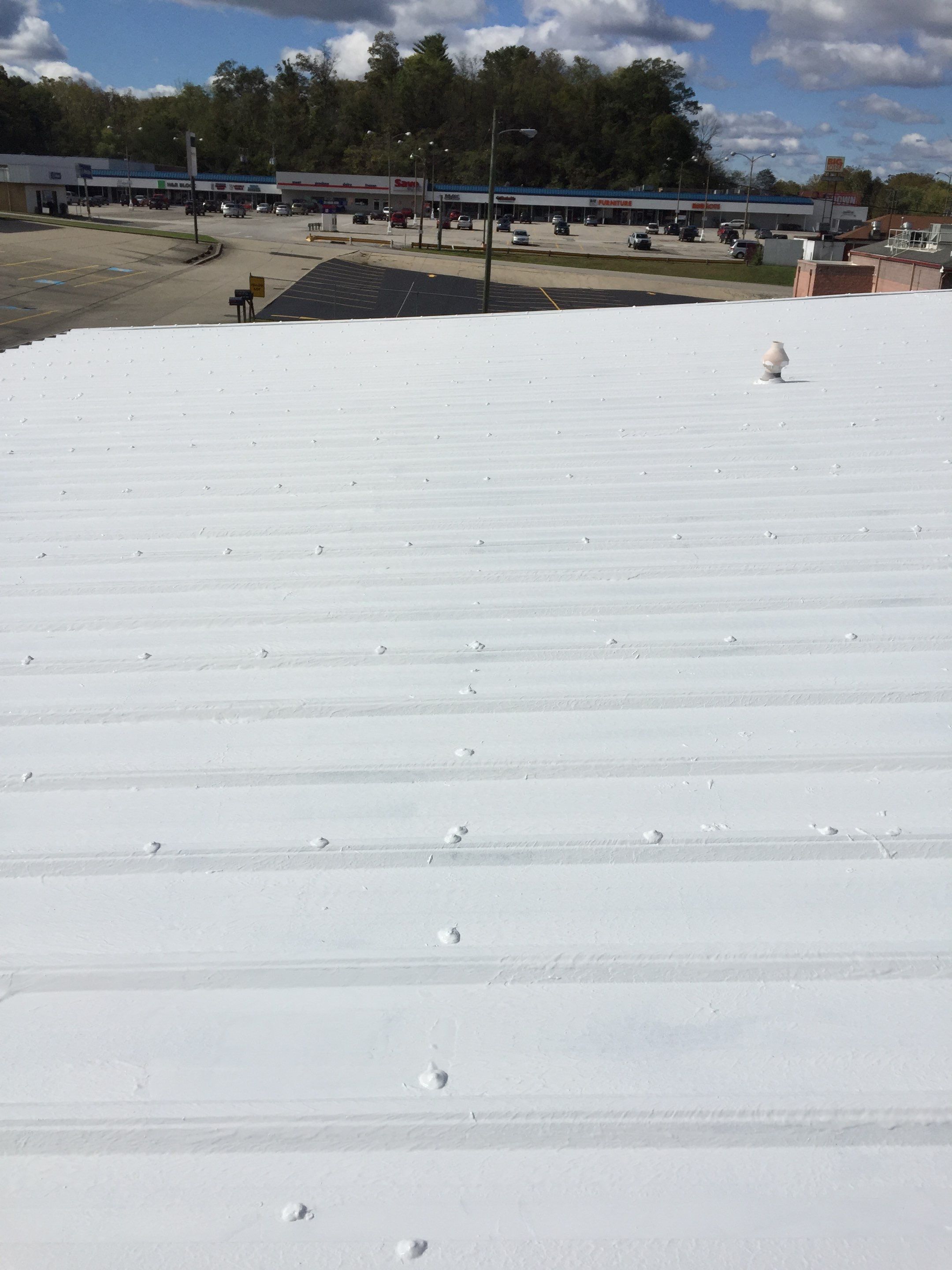 Commercial Roof Coating using Gaco Silicone Roof Coating by Secure Construction Company Inc