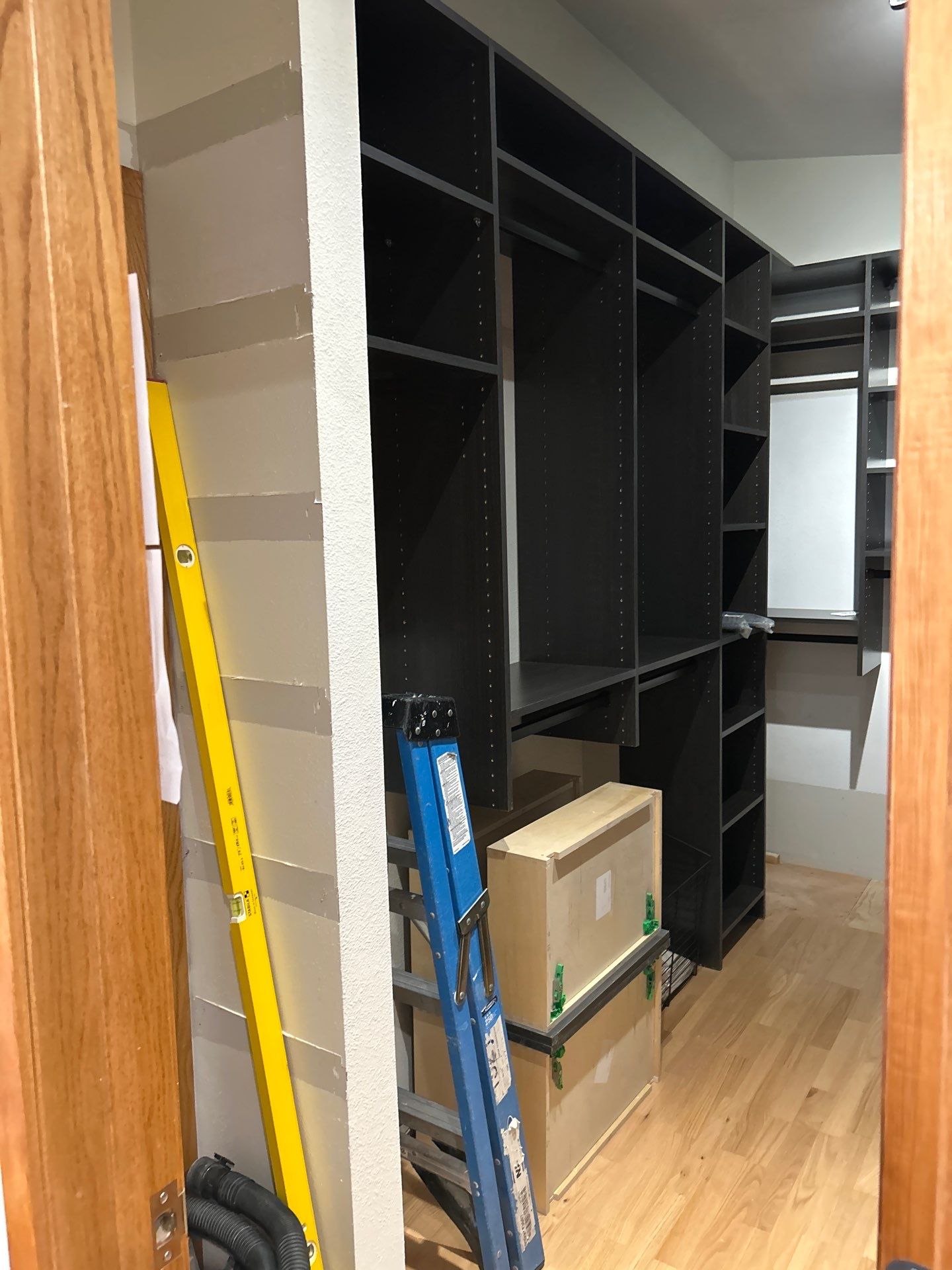 Black Riftwood Primary Closet in Centennial by Concept 32, Inc.
