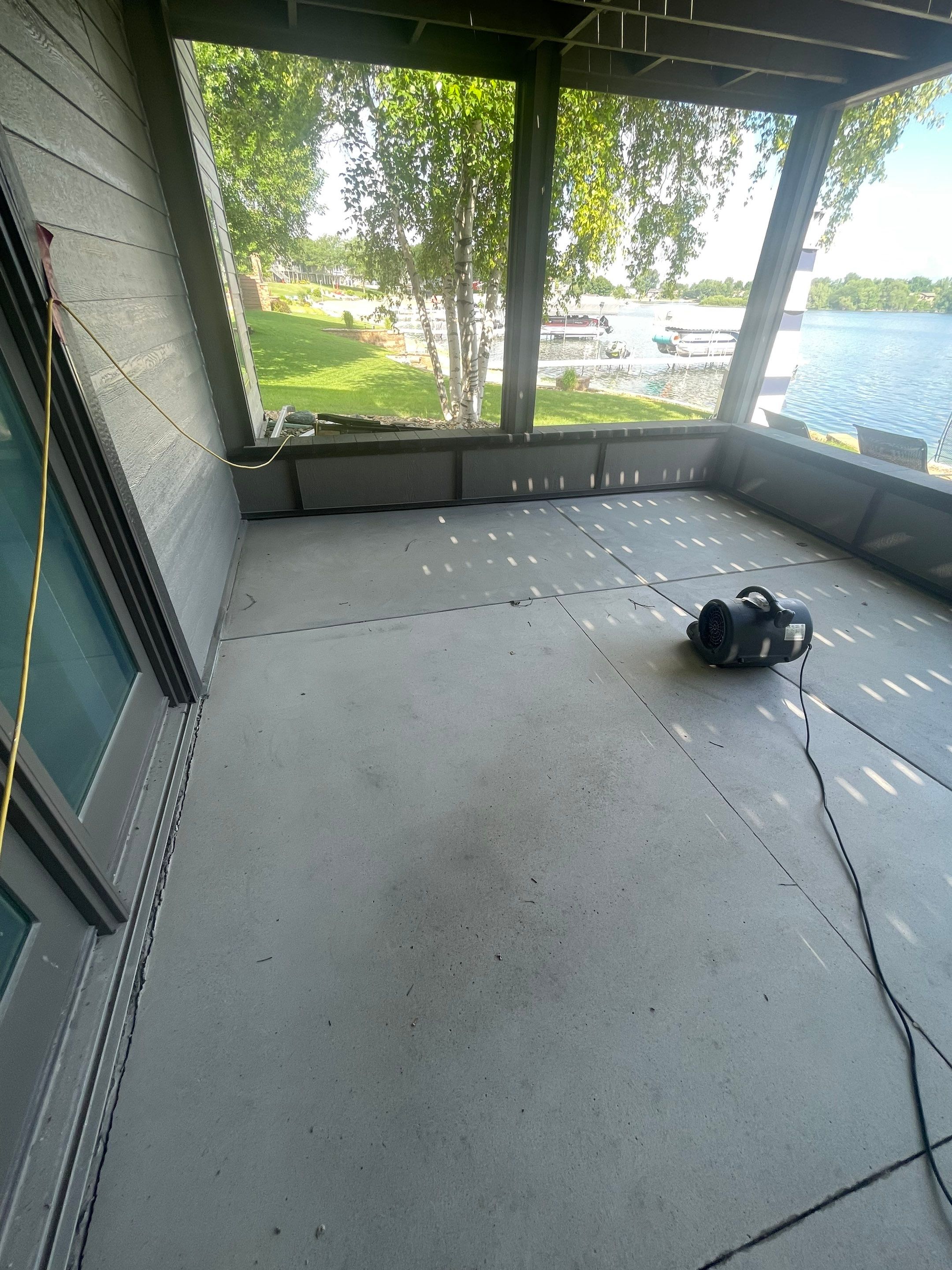 Lakefront Screened Patio Concrete Coating Installation in Wentworth by Select Painting, Coatings & Garage Cabinets