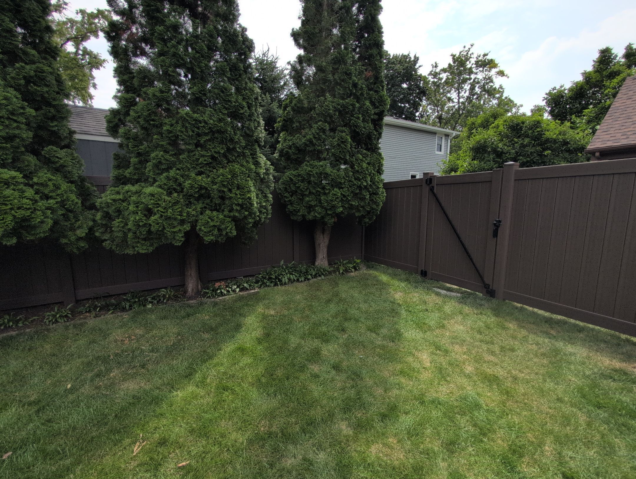 Walnut Vinyl Privacy Fence Installation in Waterloo by Perfect Picket Fence and Stain