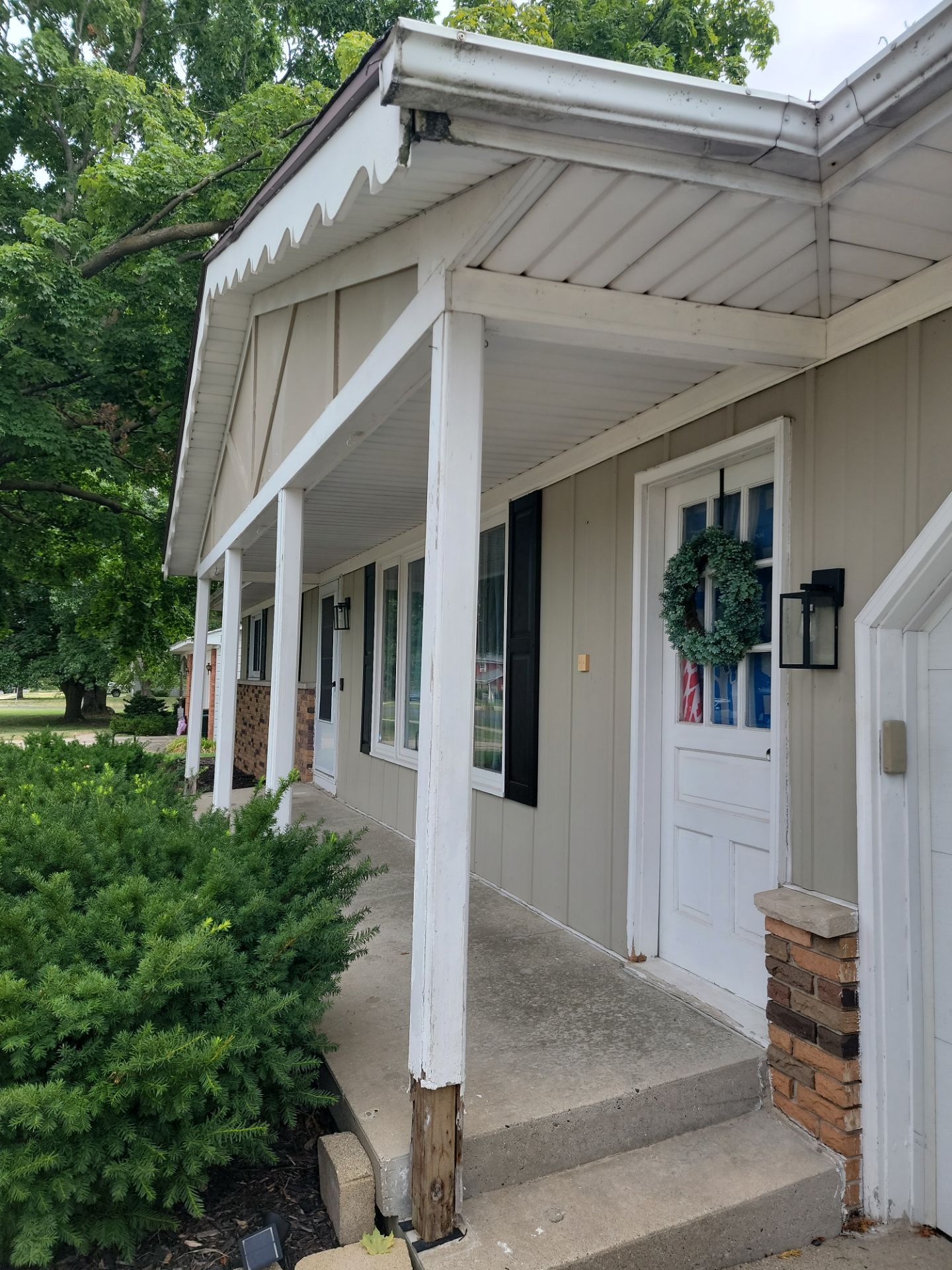 Front Porch Posts and Treated Porch Floor and Steps by Avalon Roofing and Exteriors