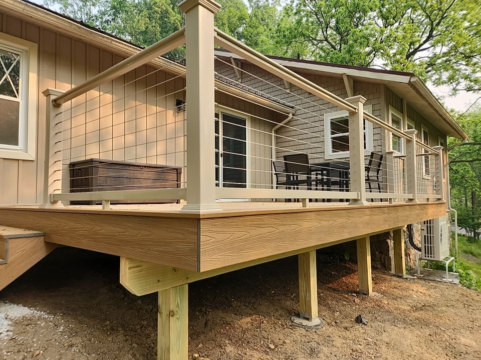 Deck installation using cable railing. by Burke Home Services