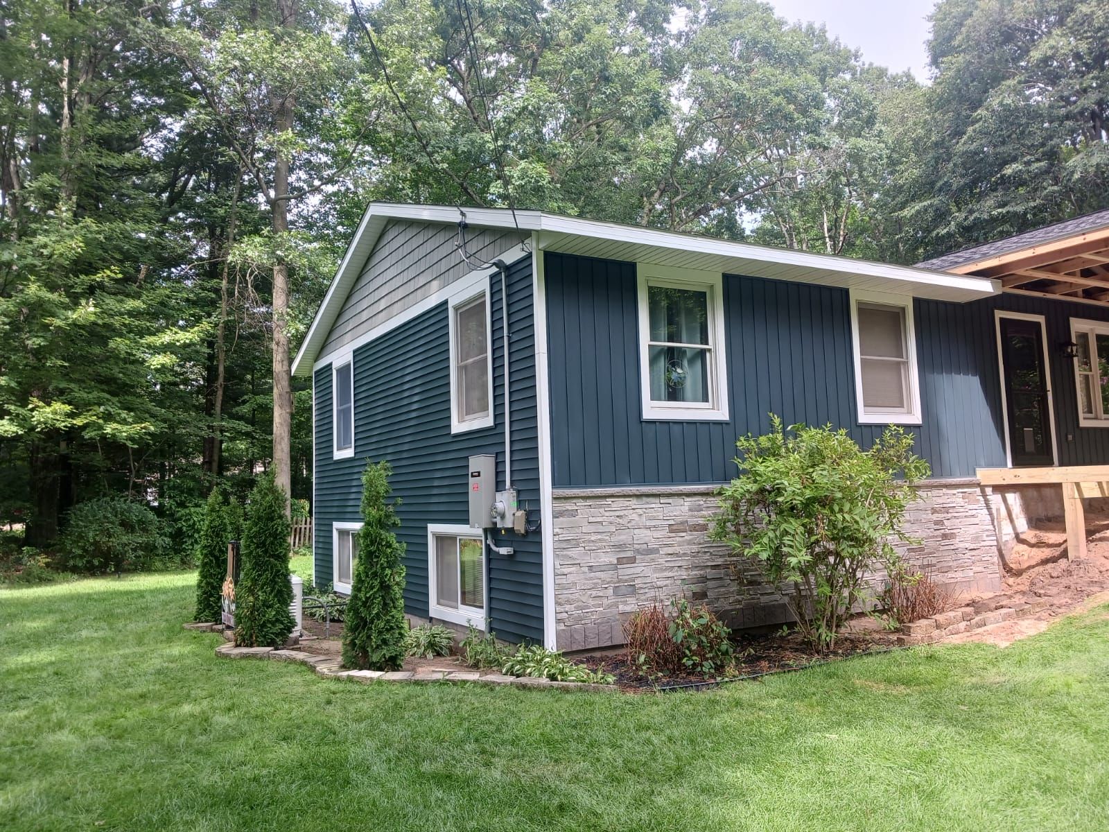 Siding, Deck and Versetta Stone by Avalon Roofing and Exteriors