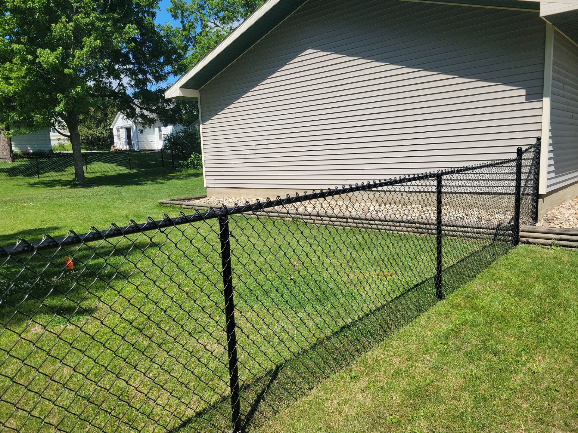 Black Chain Link Perimeter Fence and Driveway Gate in Waverly by Perfect Picket Fence and Stain