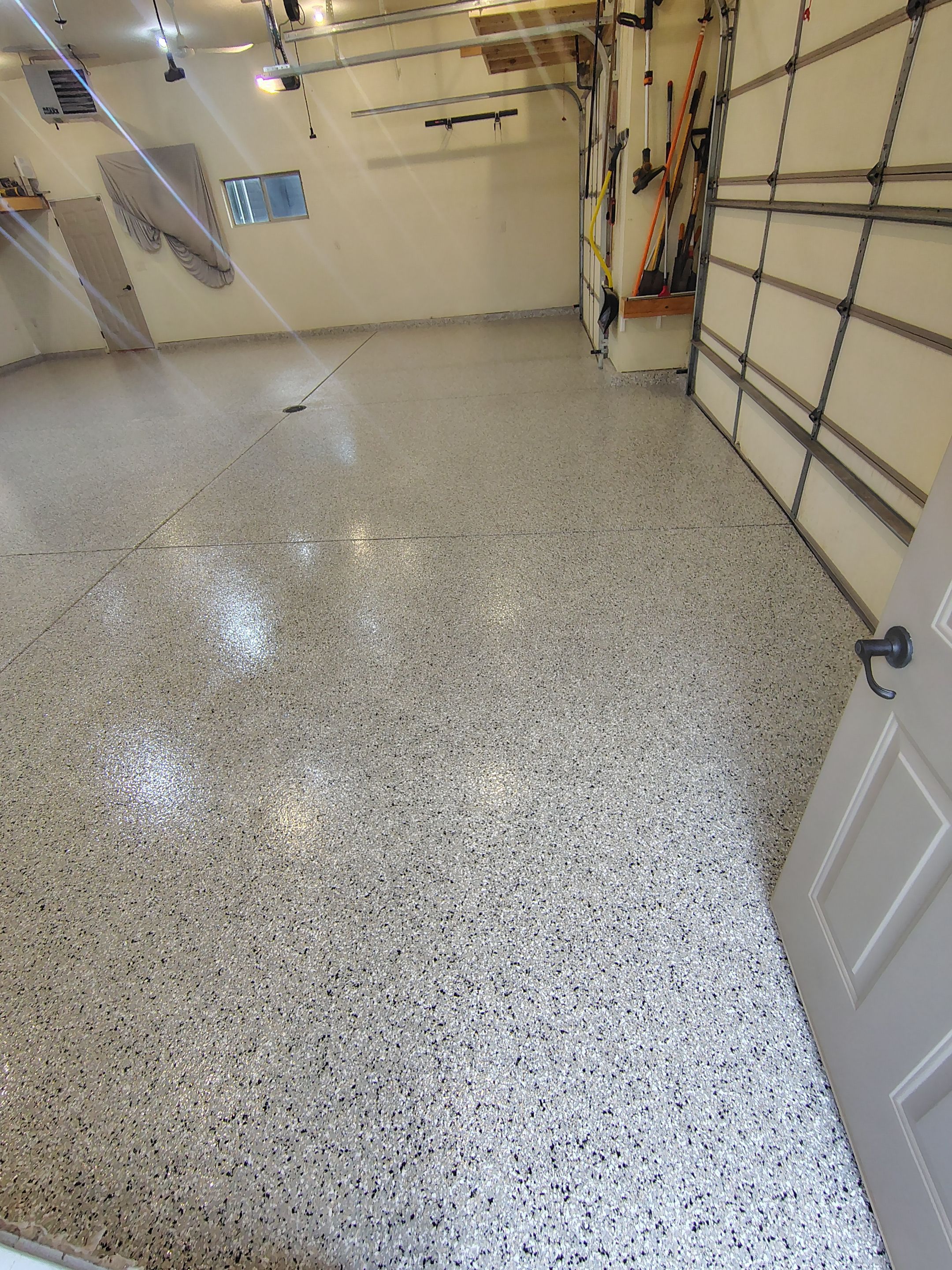 Sioux Falls Garage Floor Repair and Speckled Epoxy Coating Installation by Select Painting, Coatings & Garage Cabinets