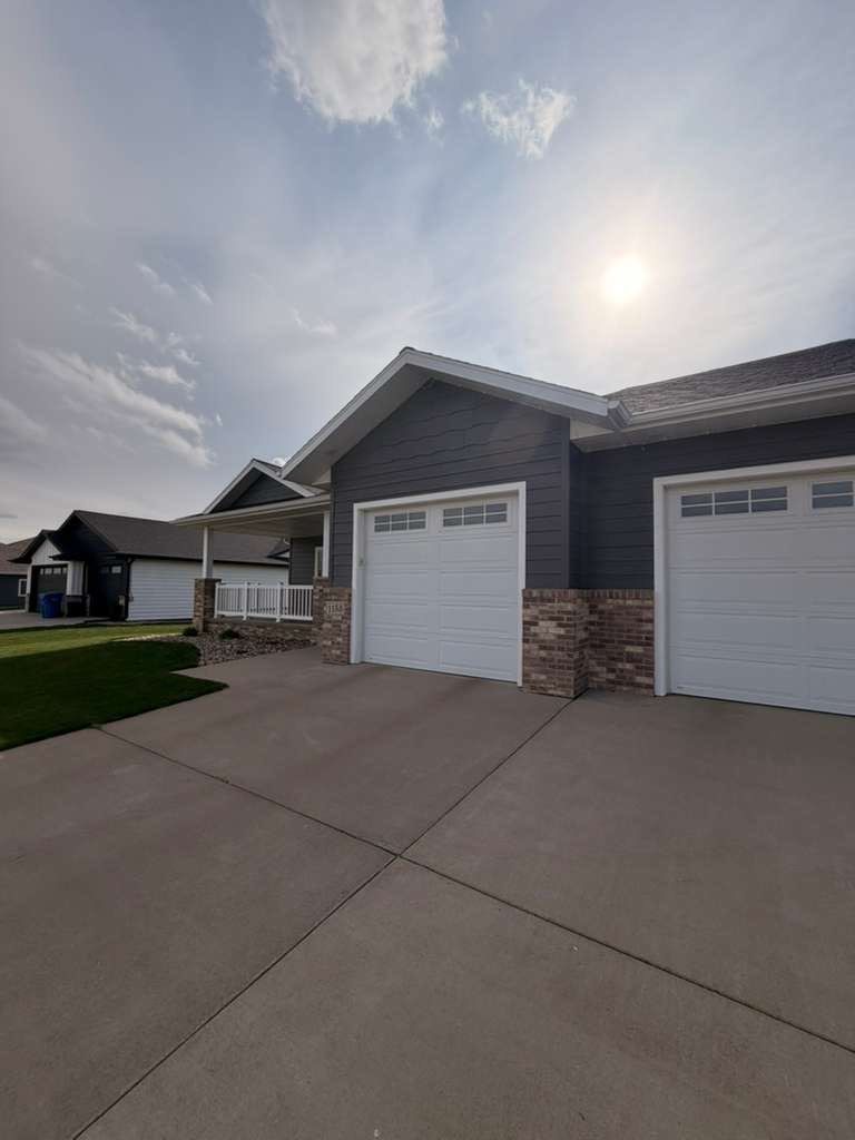 Madison Exterior Remodel with Dark Gray Siding and Stone Accents by Select Painting, Coatings & Garage Cabinets