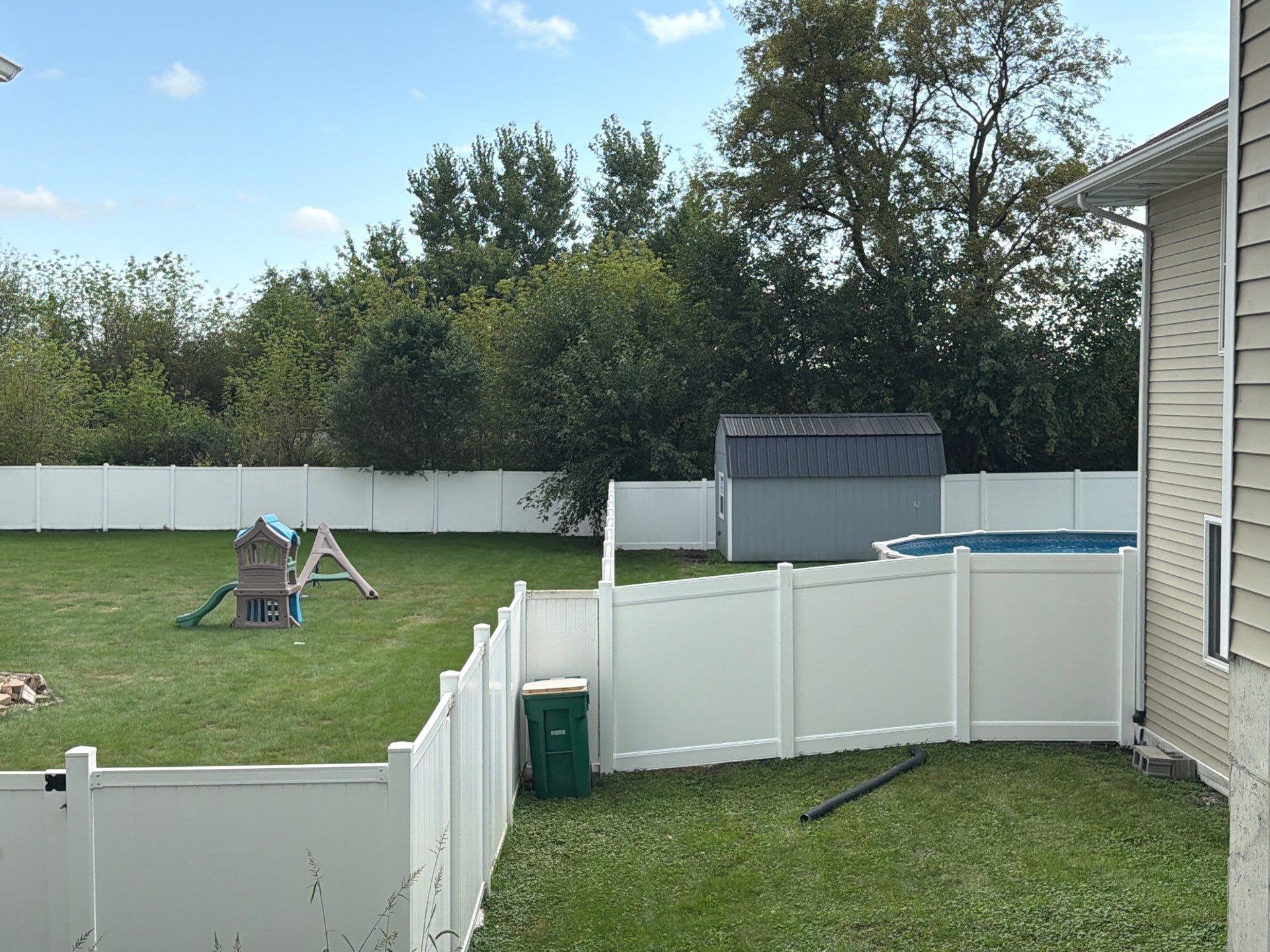White Vinyl Privacy Fence Installation in Raymond, IA by Perfect Picket Fence and Stain
