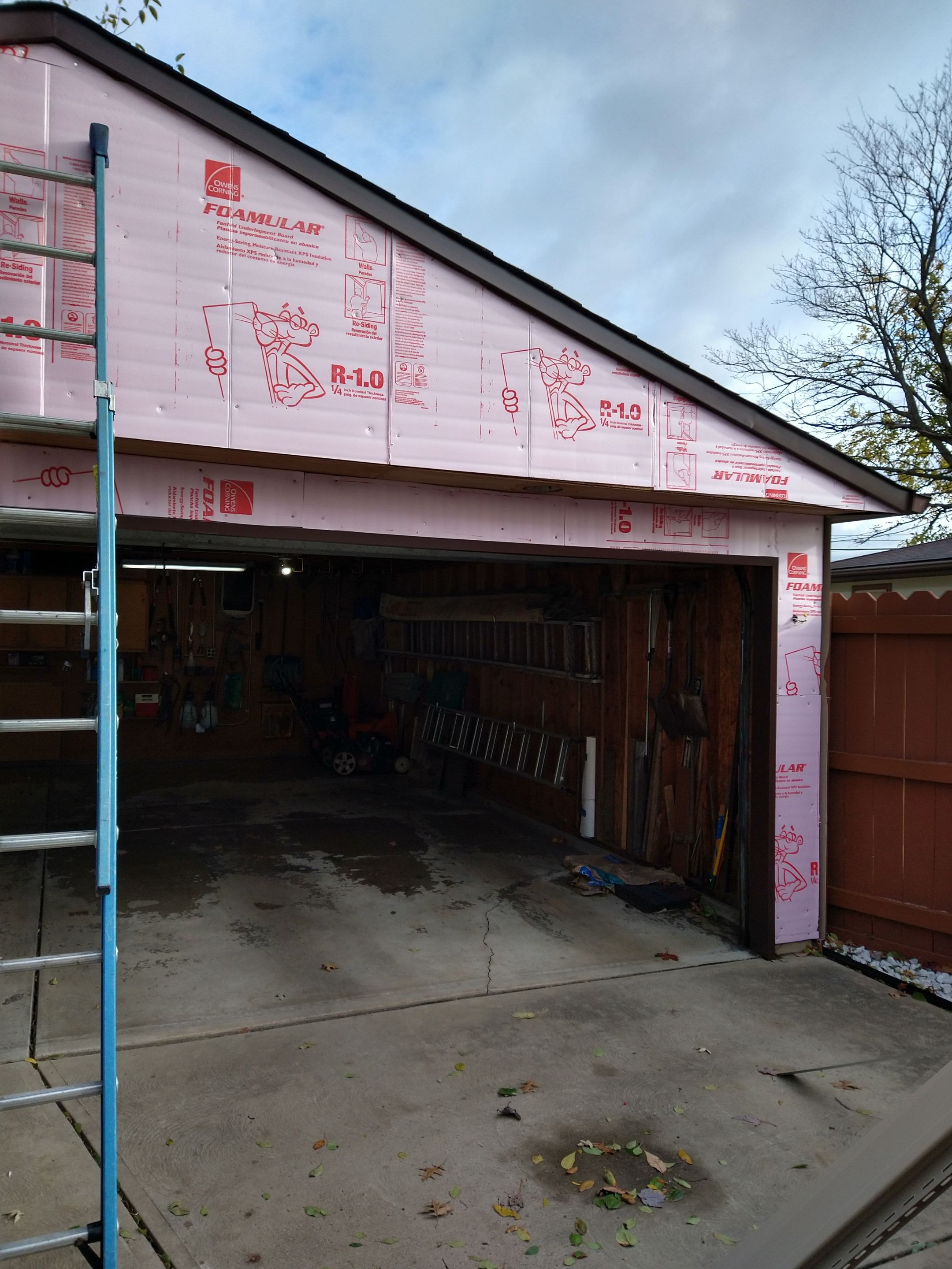 Siding Installation using Norandex woodsman dl-5 white woodgrain vinyl by Absolute Roofing and Construction
