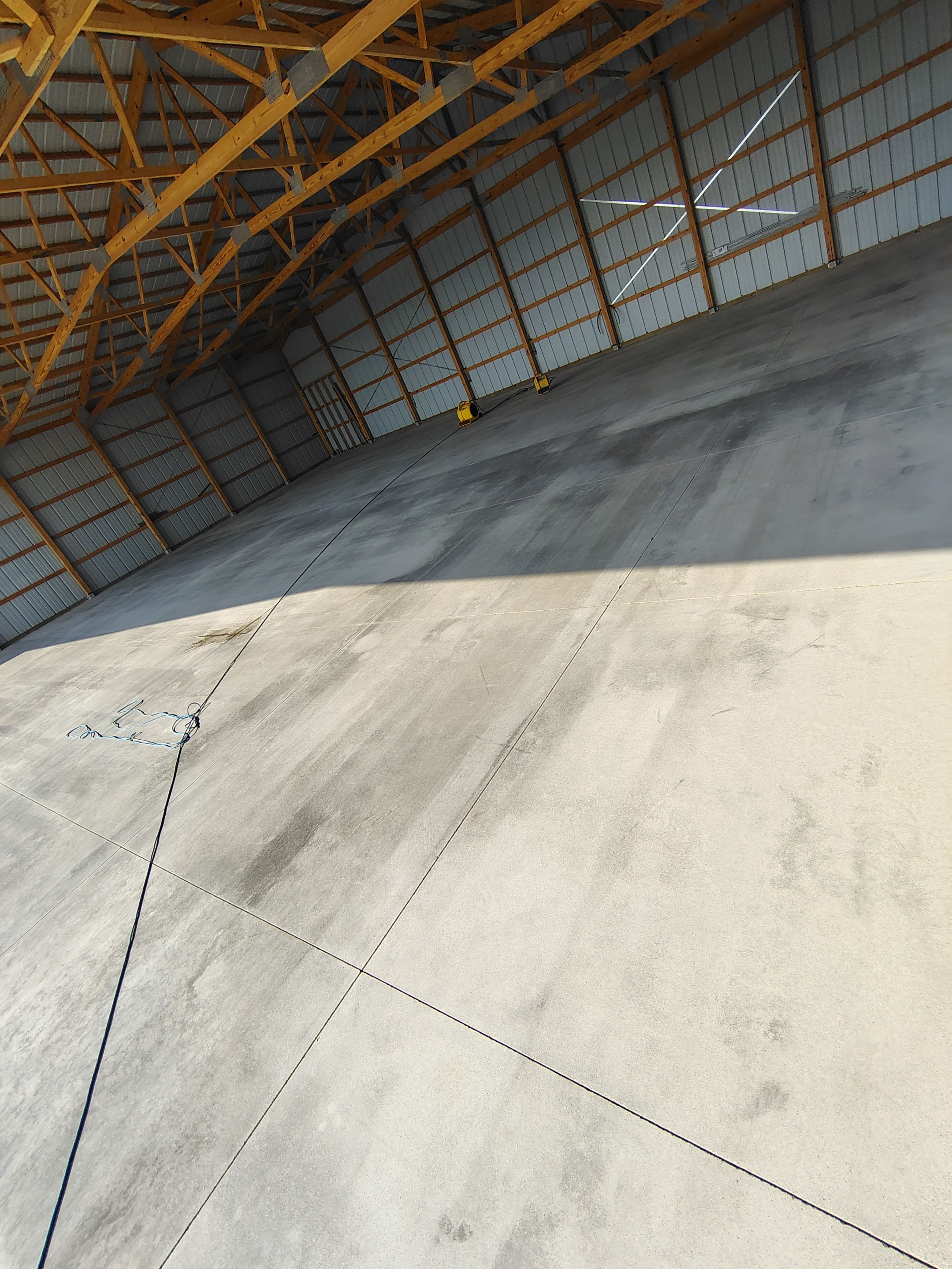 Durable Grey Speckled Epoxy Floor Coating for Yankton Shop by Select Painting, Coatings & Garage Cabinets
