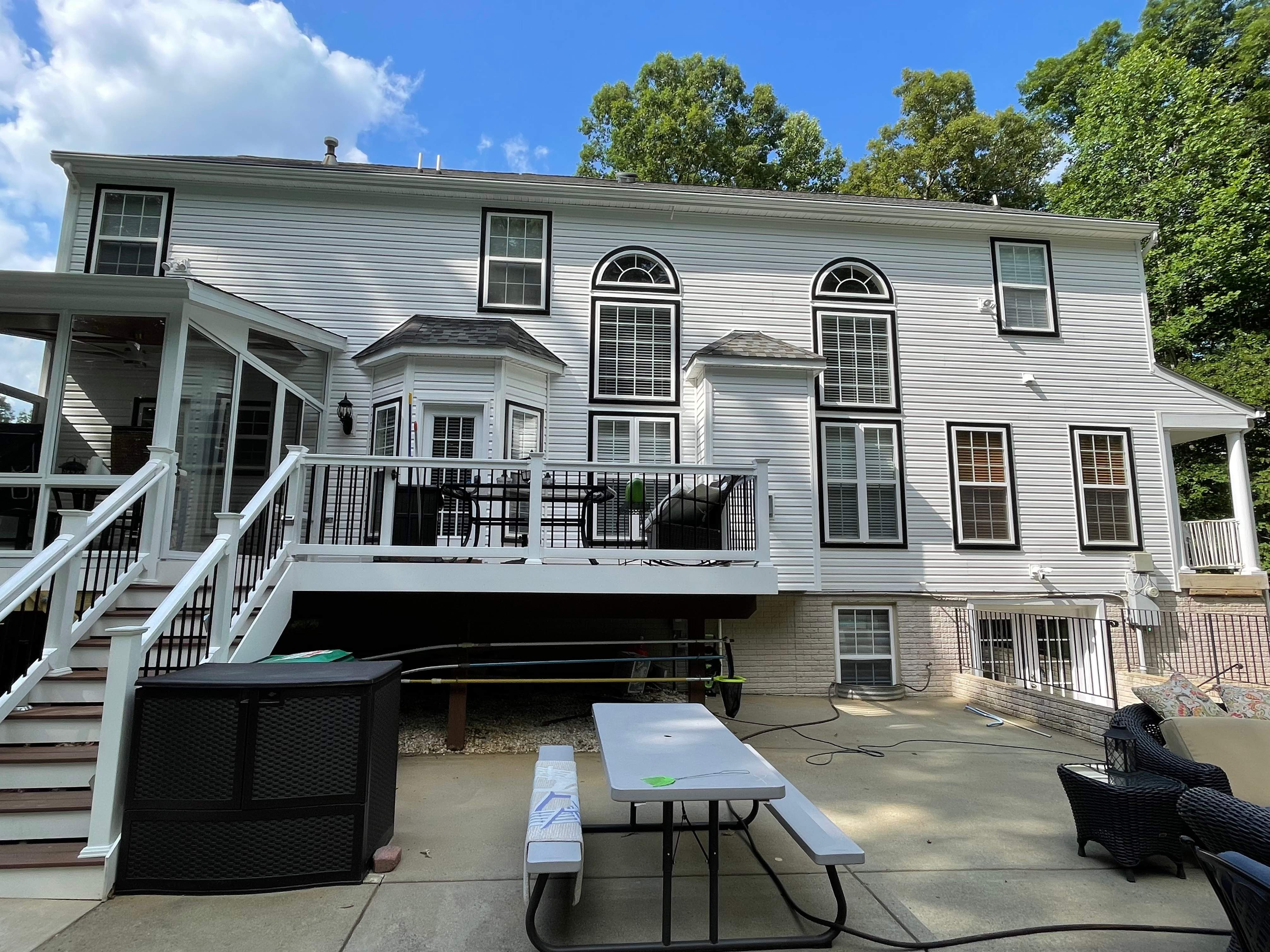 Vinyl Siding Replacement + Black Trim by American Home Contractors