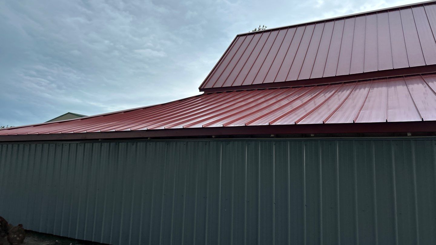 Residential Roofing Installation using Standing Seam Metal - Barn Red by RoofX 