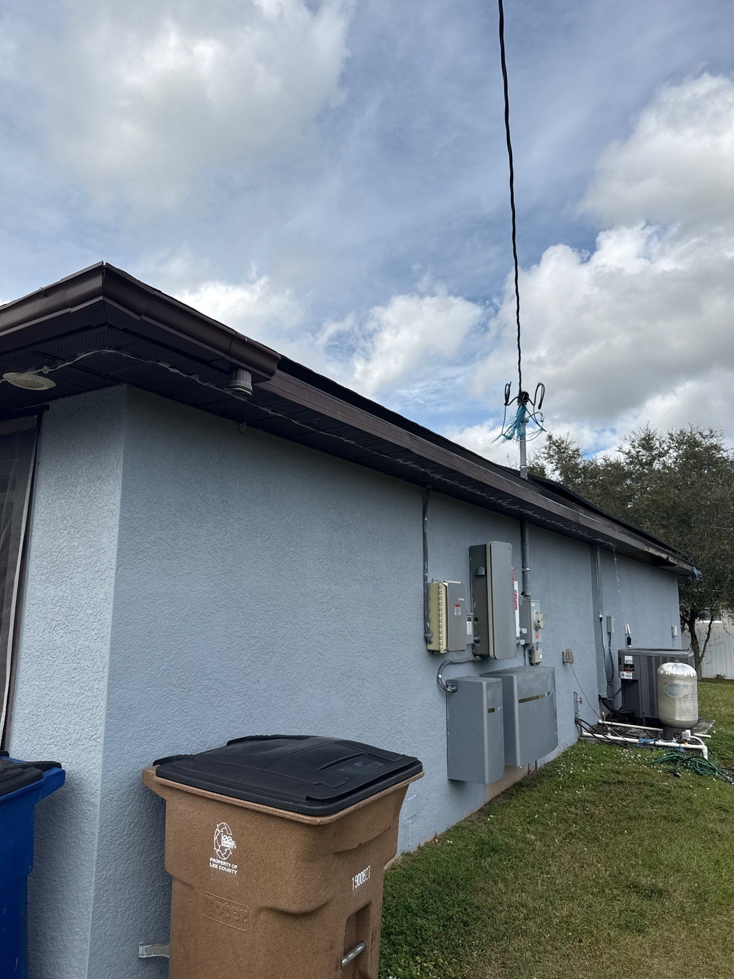 Black Seamless Gutters & Soffit/Fascia in Lehigh Acres FL by Gutter Professors
