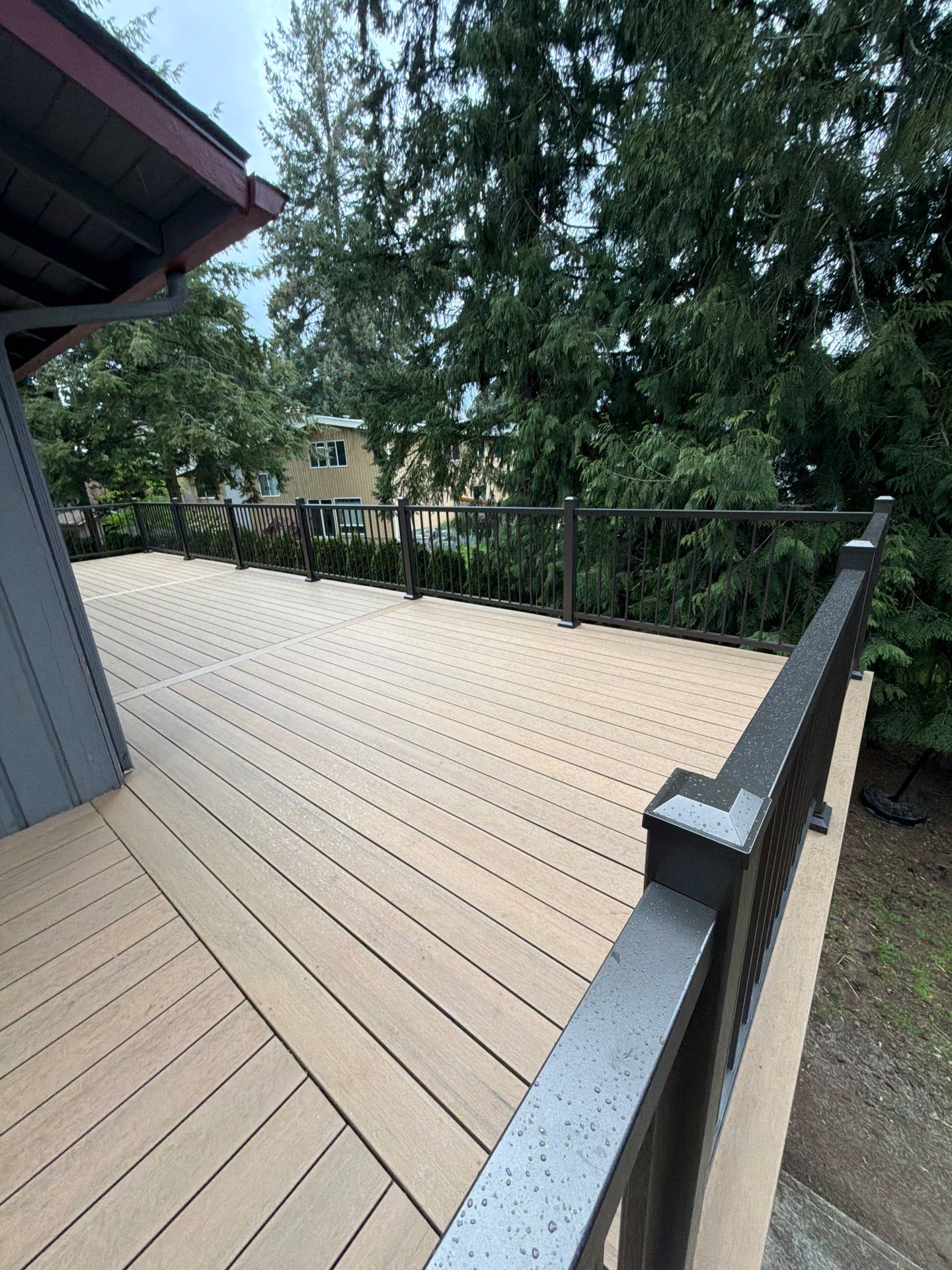 Elevated TimberTech Composite Deck Replacement With Black Metal Railings by Emerald City Energy