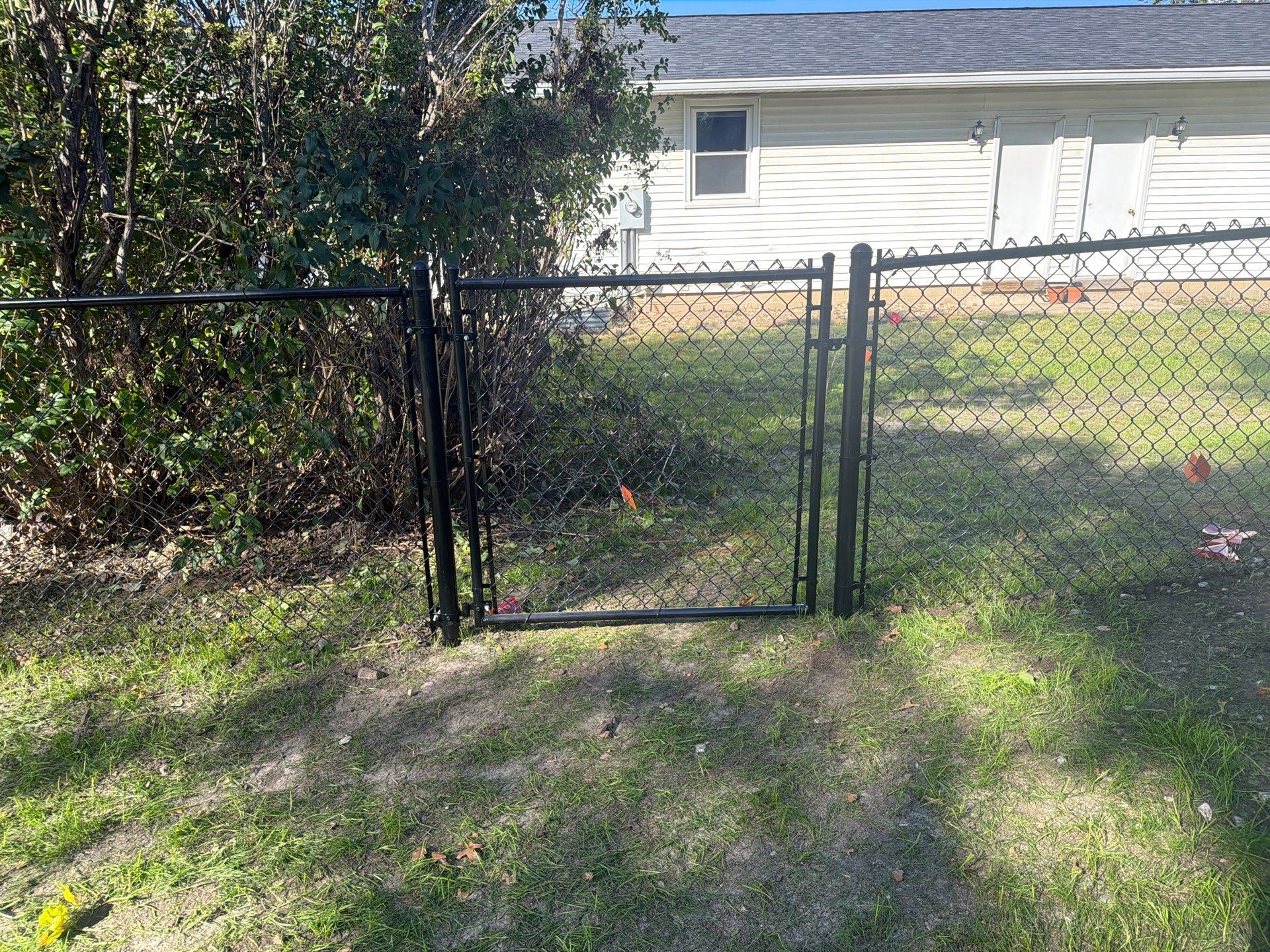 Black Chain Link Fence Installation with Double Gate in Cedar Falls by Perfect Picket Fence and Stain
