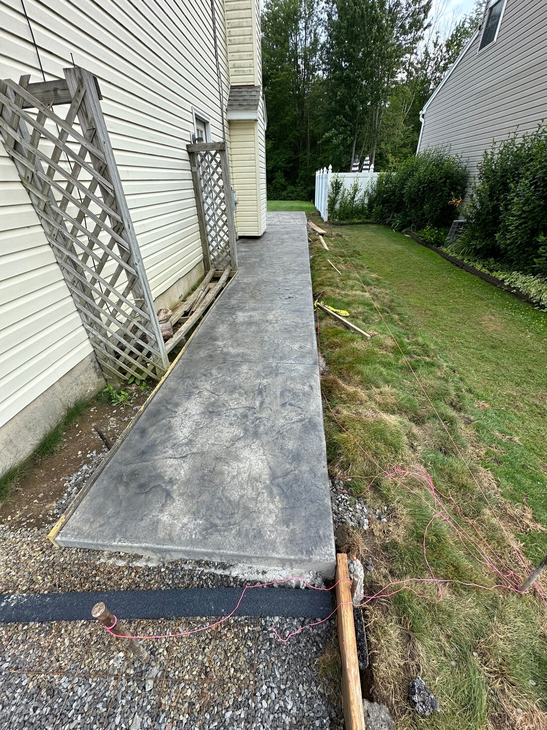Stamped Concrete, Entry Door, and Concrete  by Ivy Lea Construction