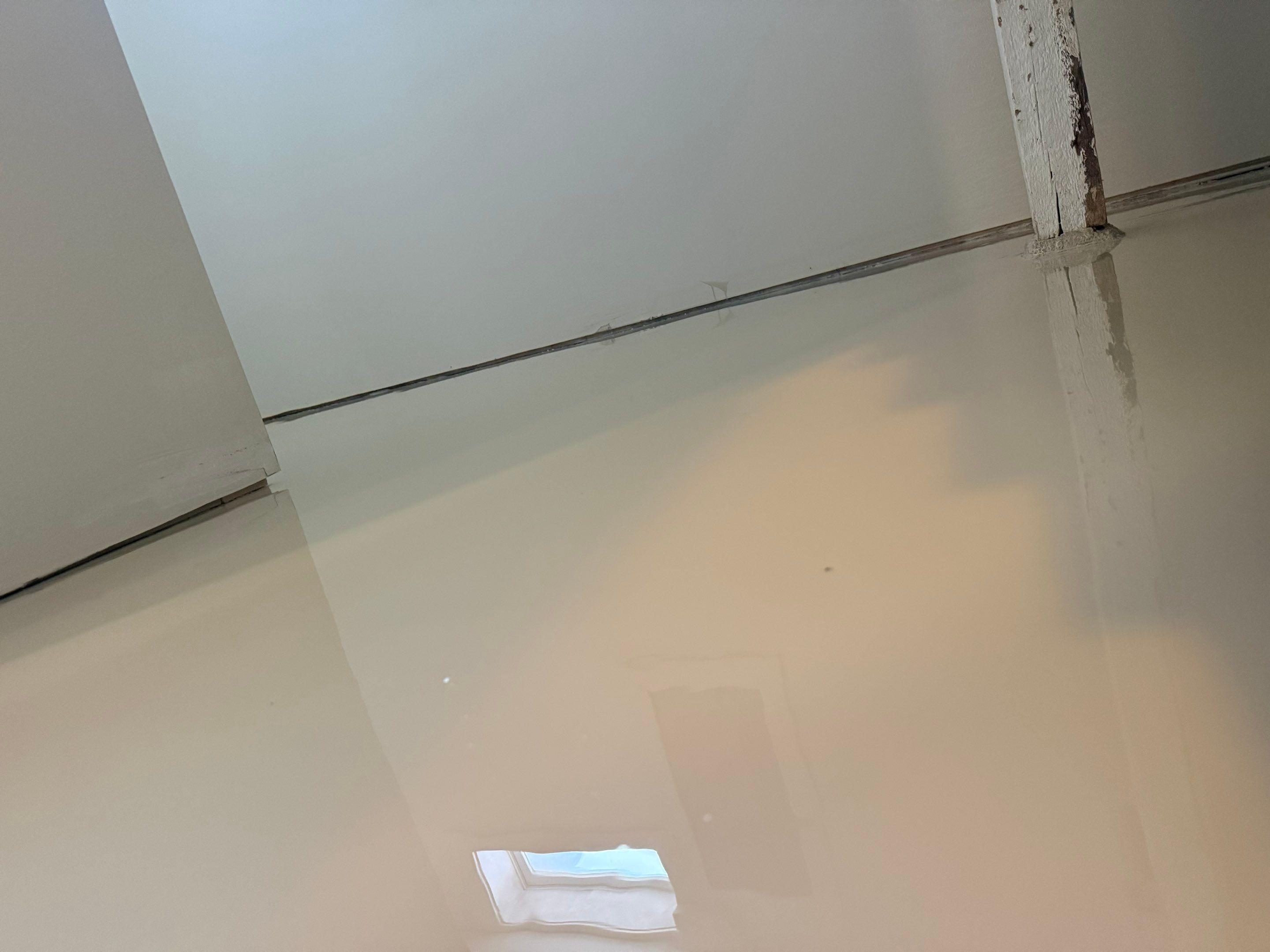 High-Gloss Epoxy Floor Coating and Basement Renovation in Rock Rapids by Select Painting, Coatings & Garage Cabinets