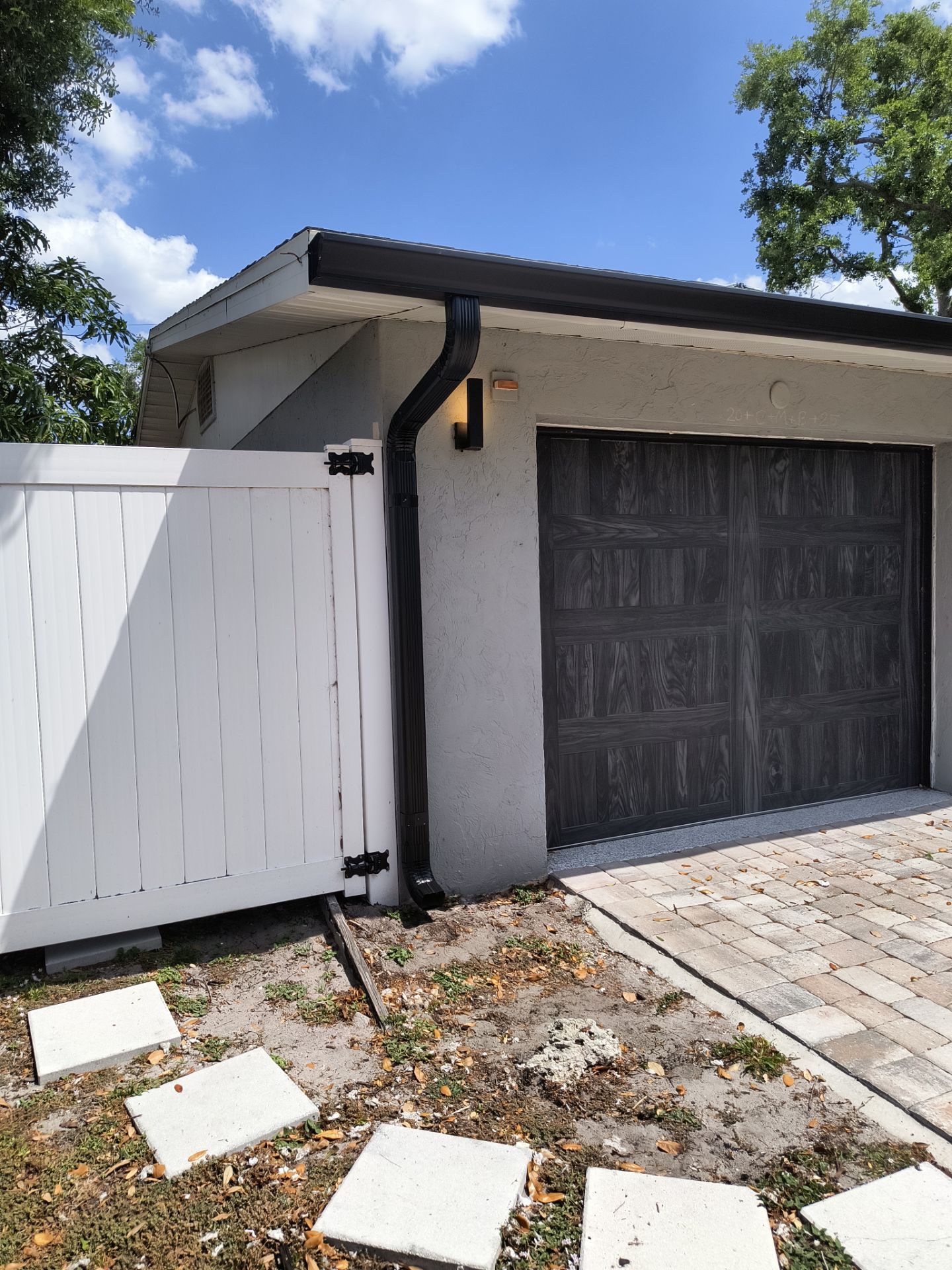 Black Seamless Gutters using 7 inch seamless gutters & New White Soffit in Sarasota FL by Gutter Professors