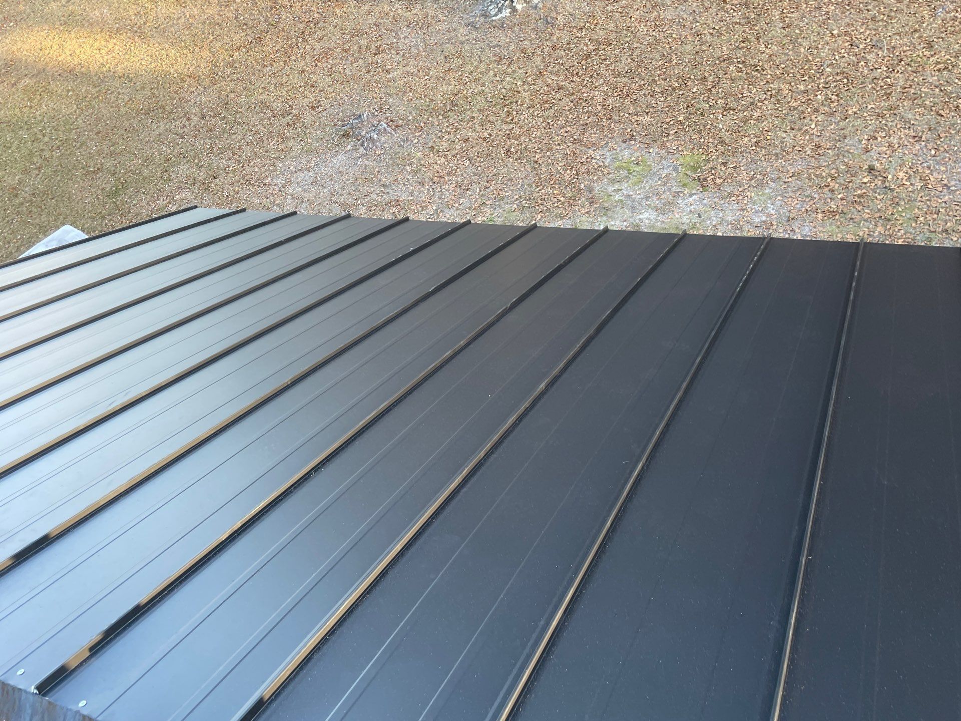 Residential Roofing Installation using Benton 26Ga 1inc Snapcock Metal Roof KYNAR Matte Black by Talya Roofing