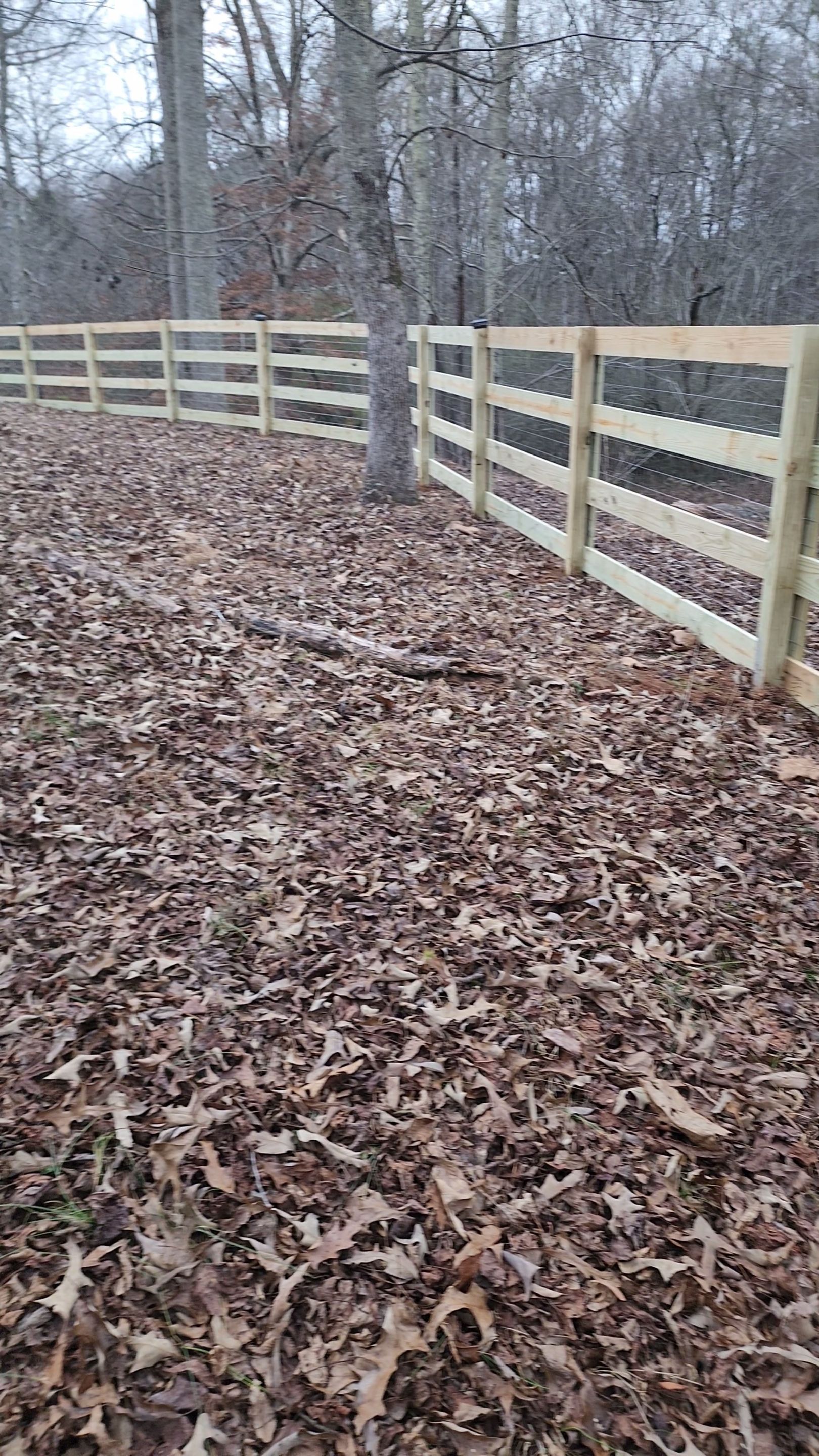 Fence Installation of 4 Rail Ranch Fence with Welded Wire by Titans of Timber Fence & Stain