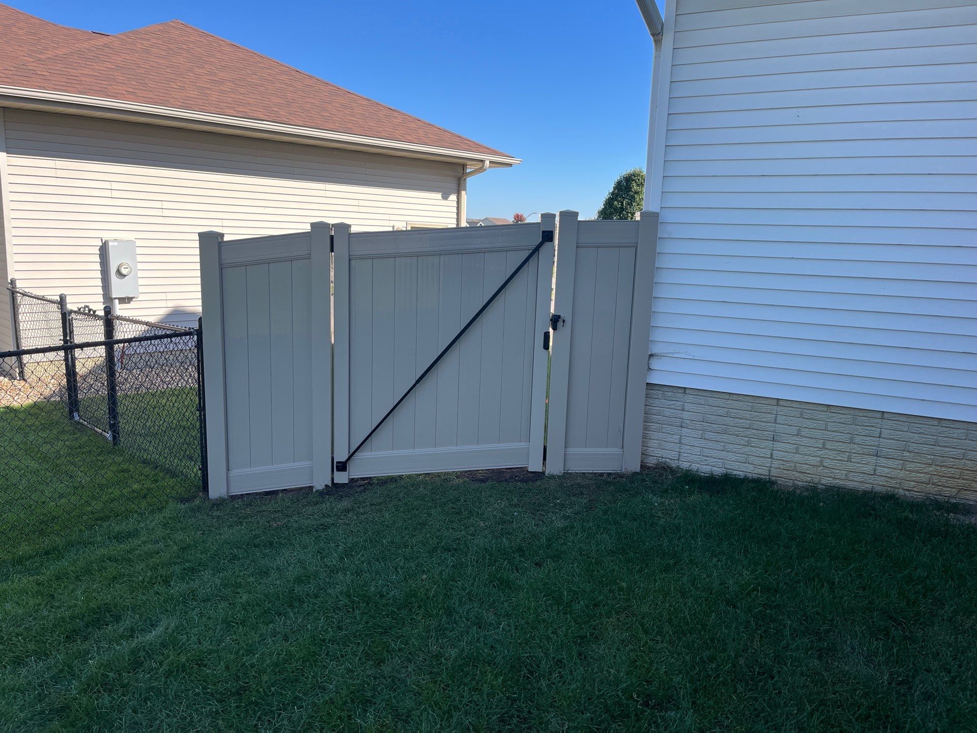 Adobe Vinyl Privacy Fence and Gate Installation in Cedar Falls by Perfect Picket Fence and Stain