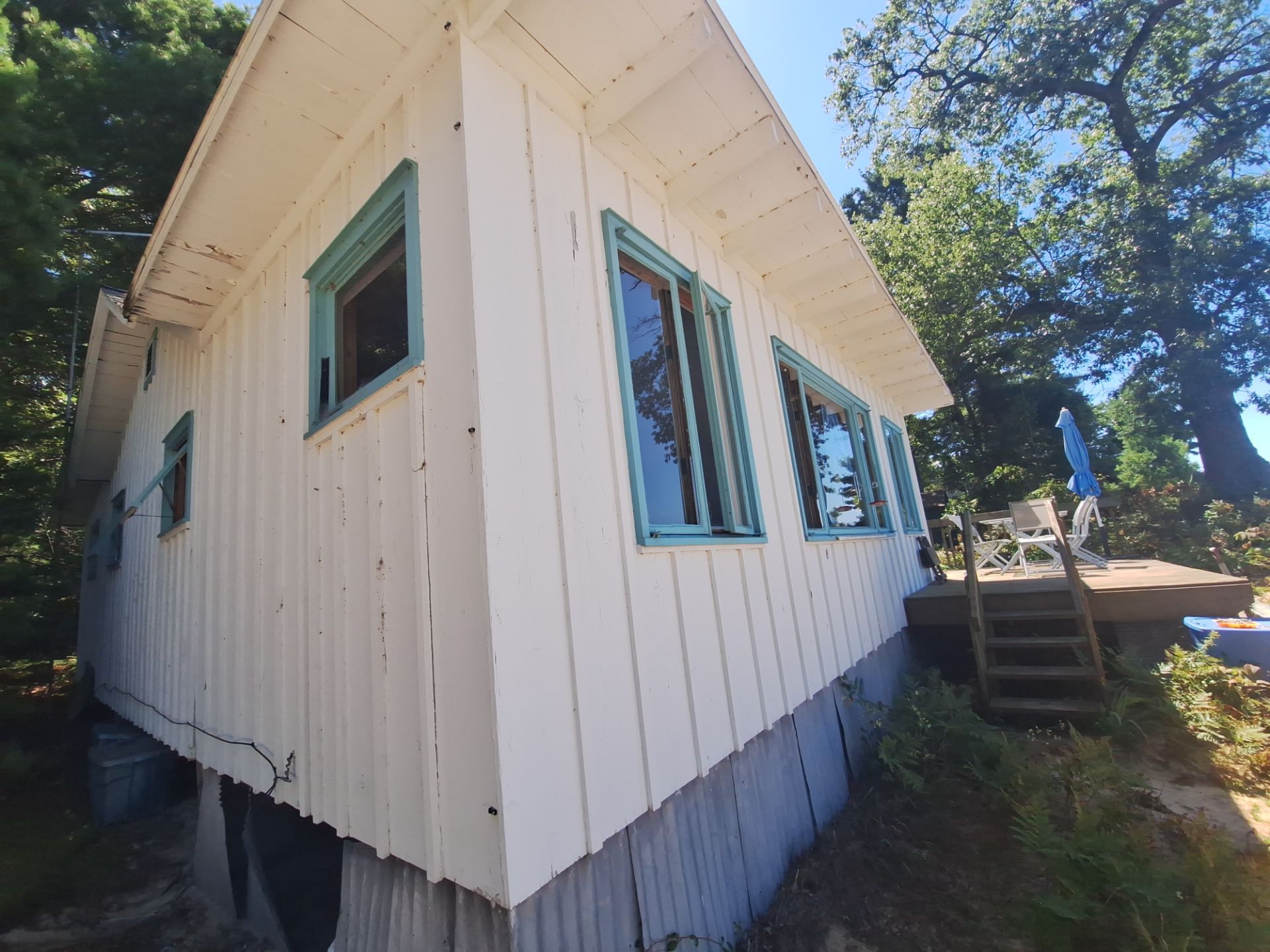 Lakeside Cottage Exterior Painting and Teal Trim Restoration in Mears by Gordon Painting