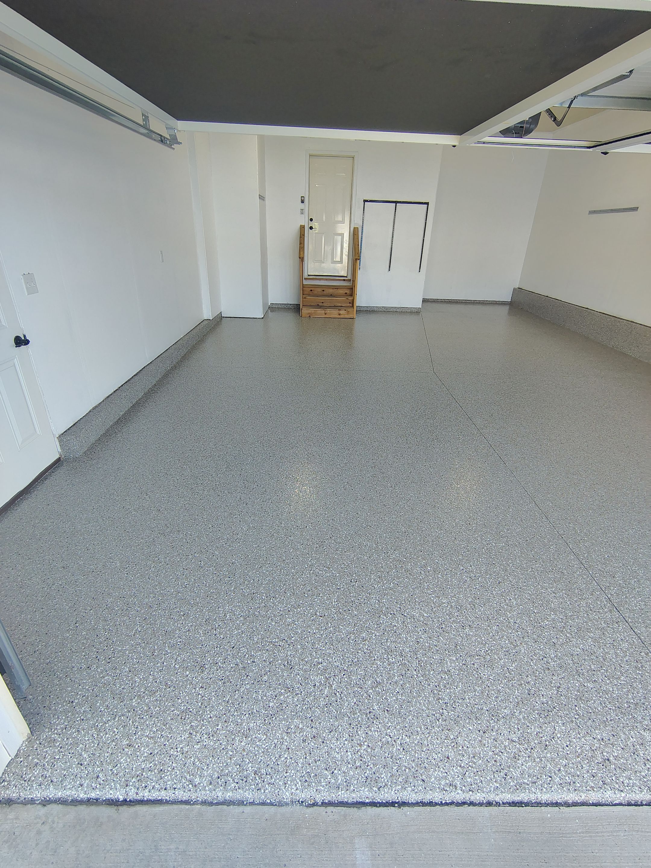 Sioux Falls Garage Floor Transformation With Gray Speckled Epoxy Coating by Select Painting, Coatings & Garage Cabinets