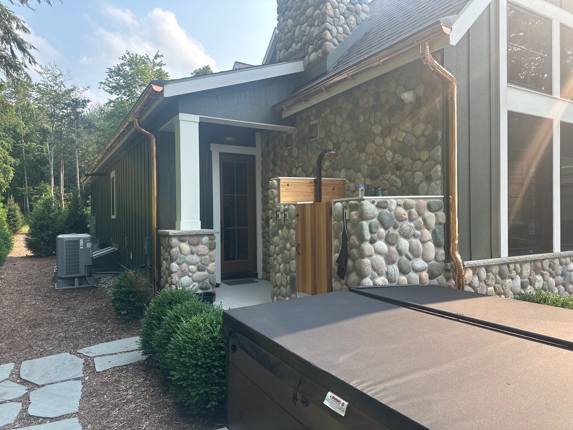 Copper Gutter and Downspout Installation for Omena Residence by Rainbow Seamless Systems